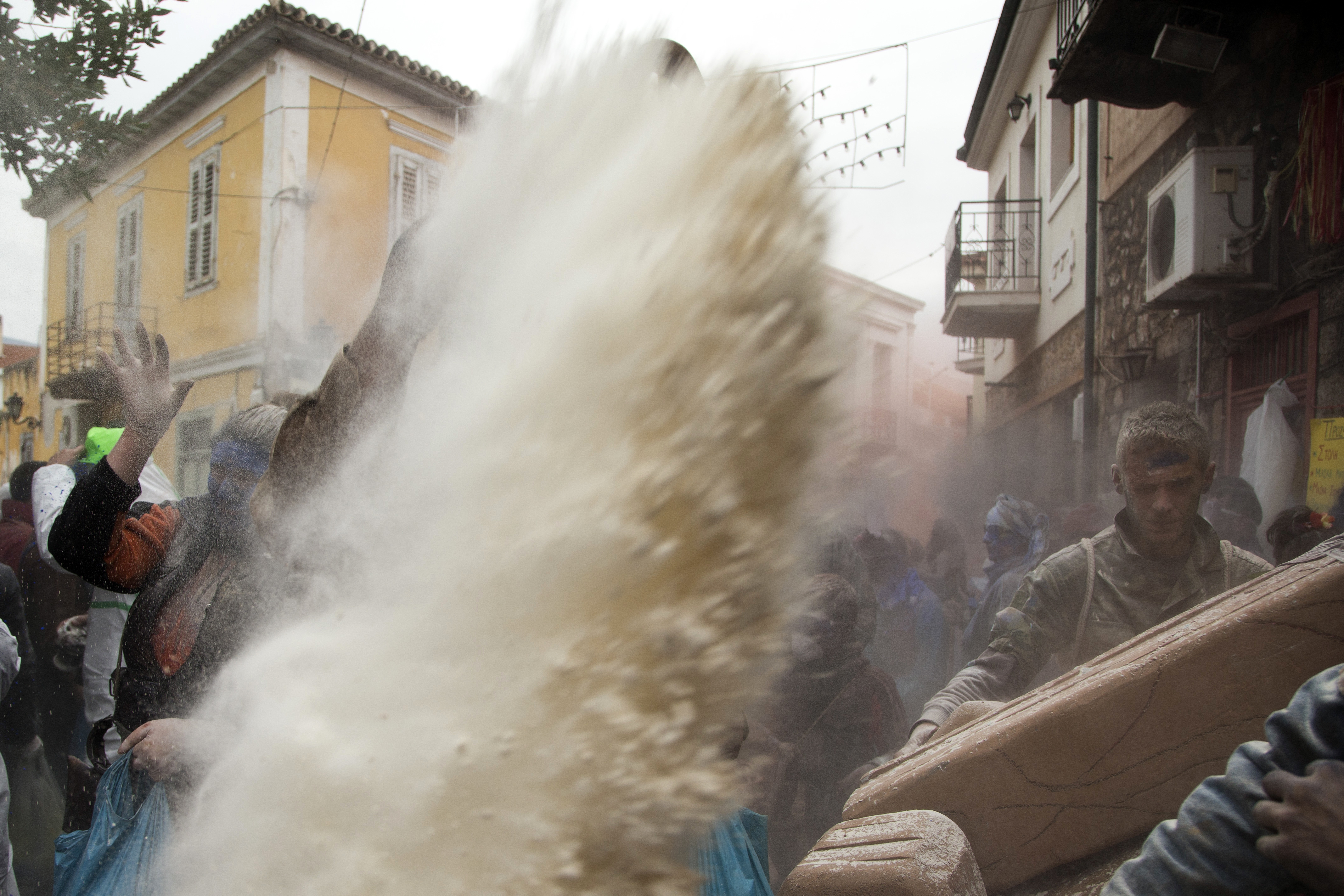 Flour is hurled at the climax of the Carnival season (Petros Giannakouris/AP)