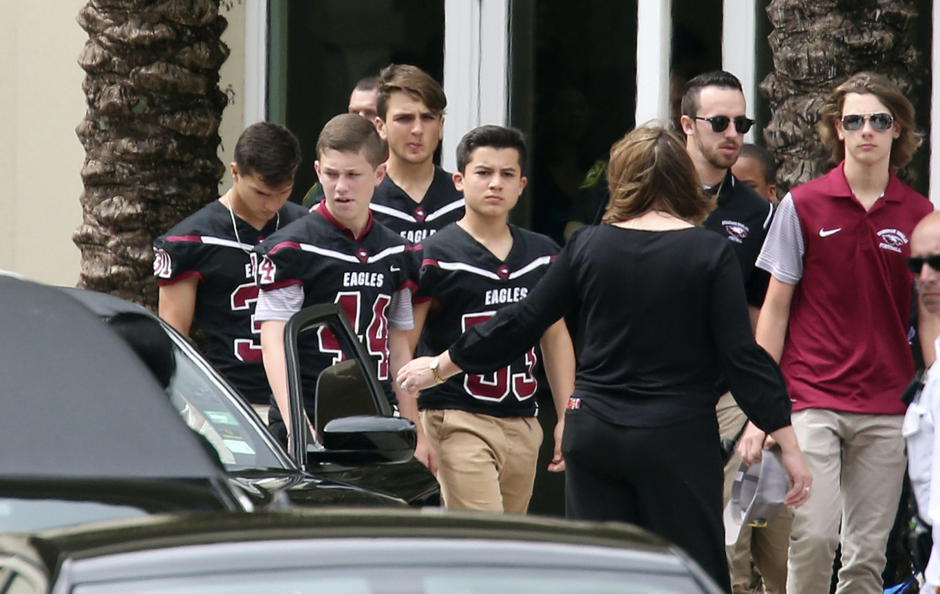 Members of the Marjory Stoneman Douglas High School football team depart after the funeral service for Aaron Feis (AP)
