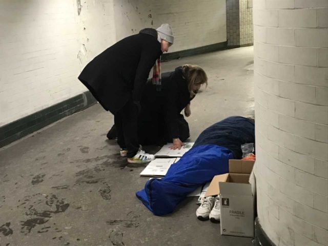 St Mungo's outreach team speak to a homeless person sleeping rough in a tube subway (Jemma Crew/PA)