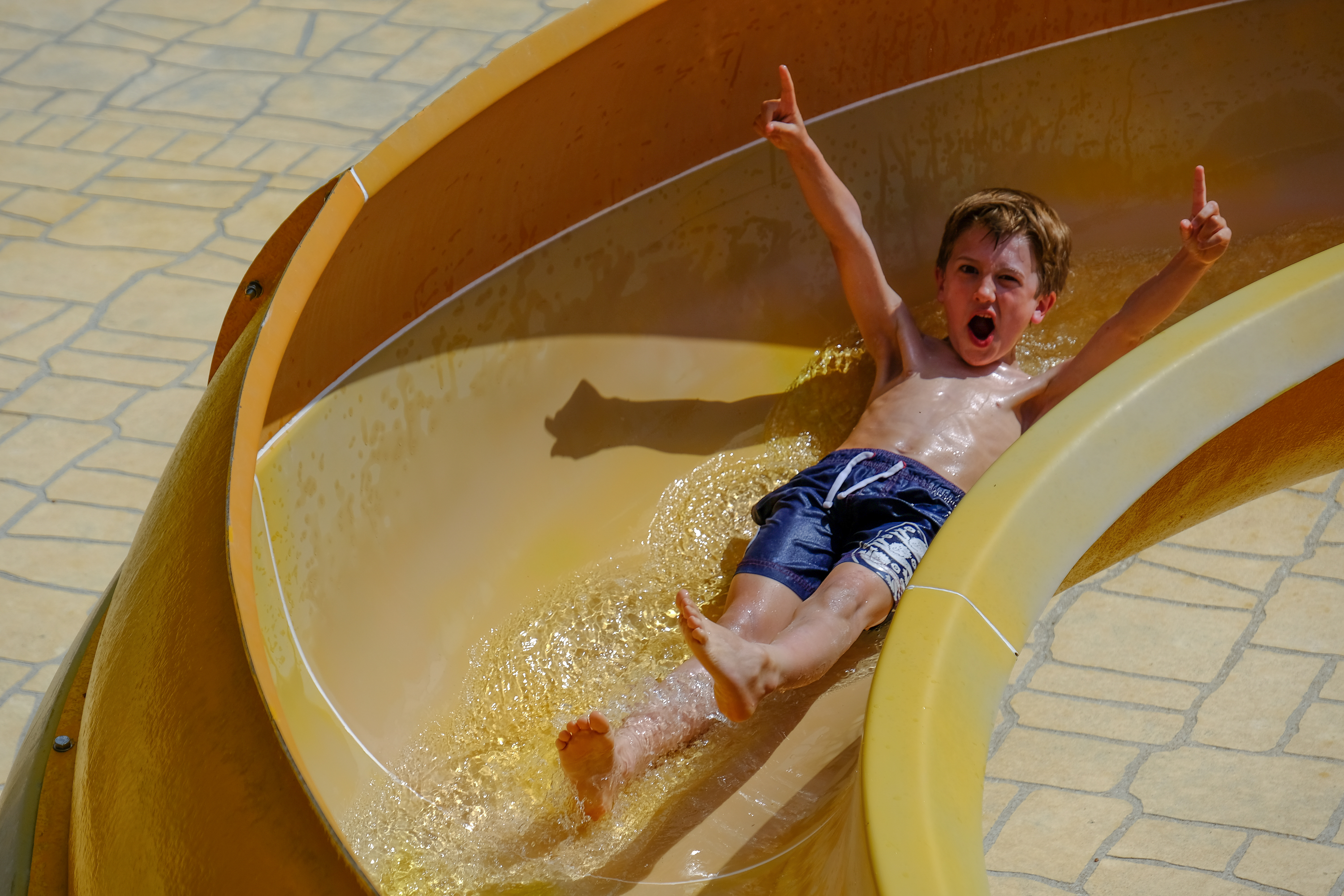 Oscar takes a plunge on the water slide (Warren Chrismas/PA)