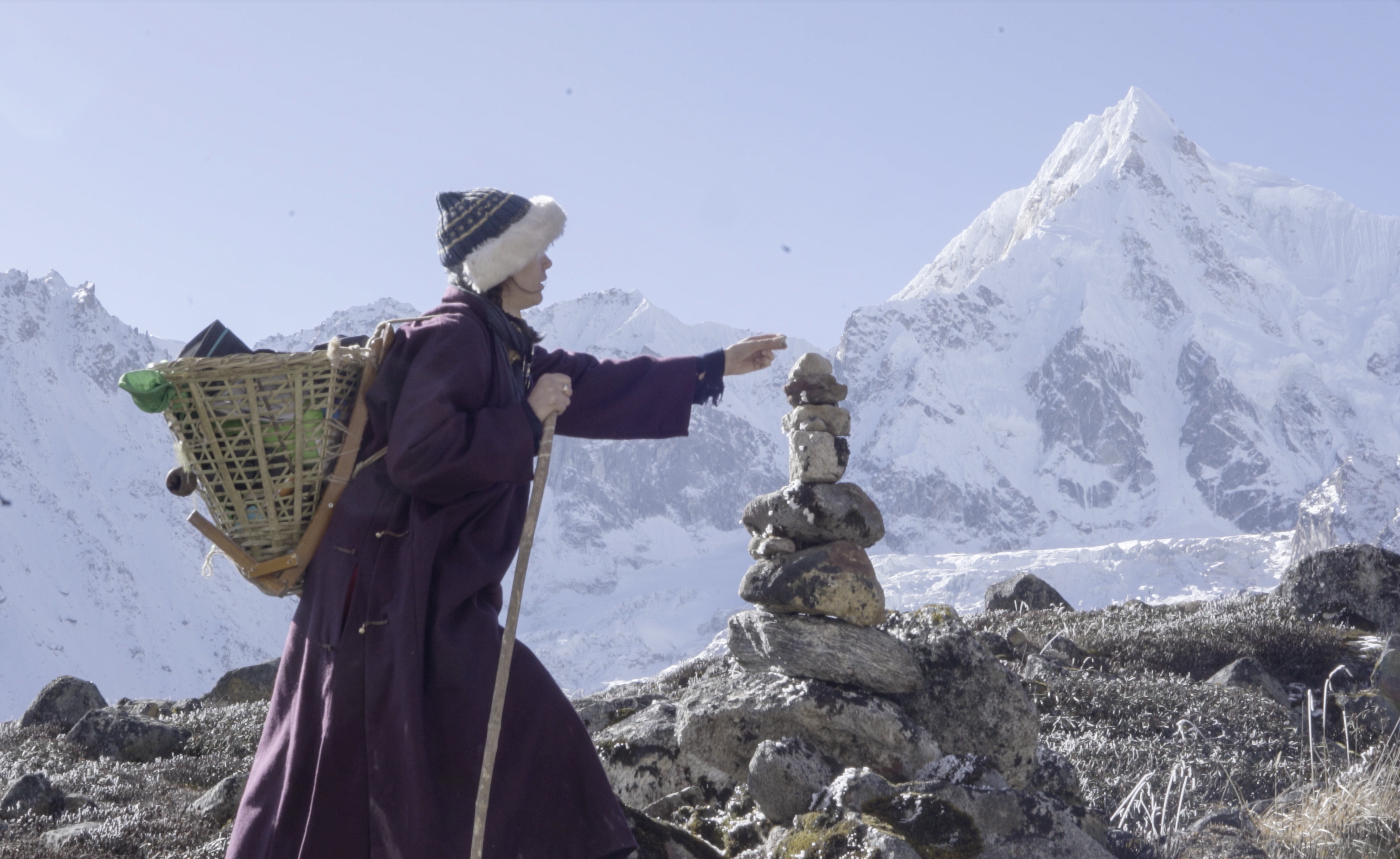 Elise places a stone on a cairn