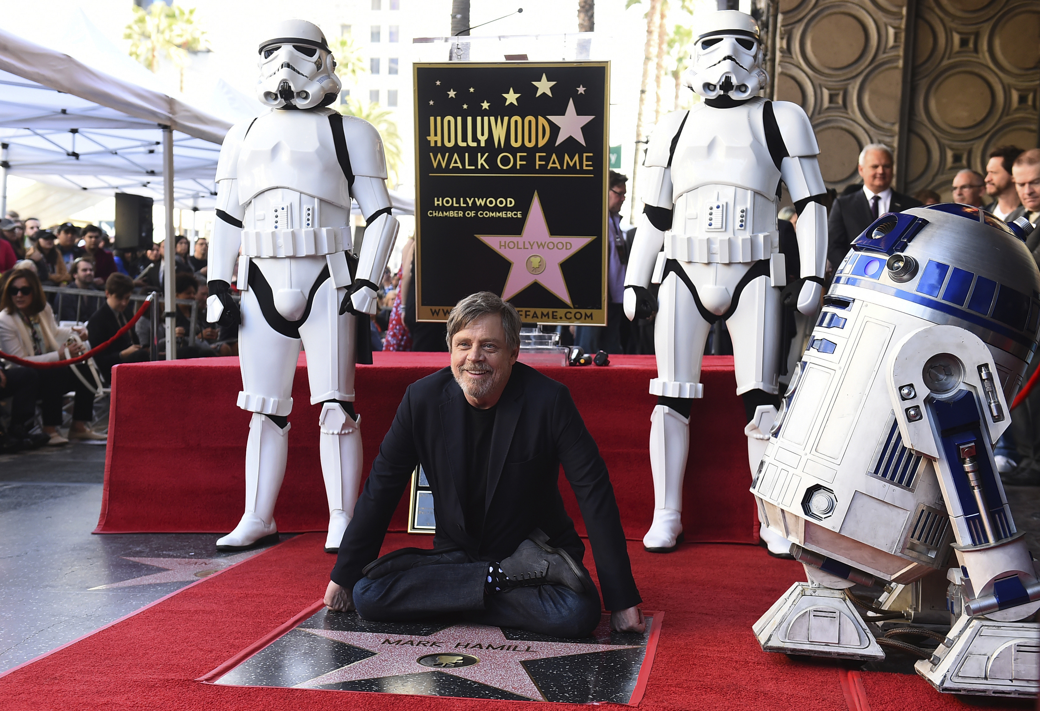 Mark Hamill sits by his star