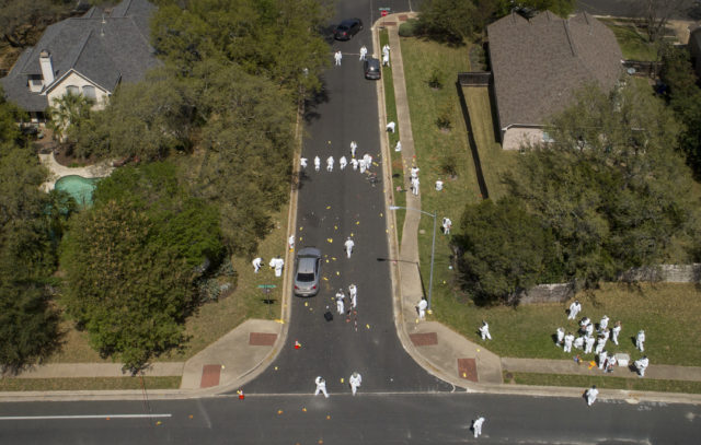 Investigators at the scene of a bomb explosion on Sunday in Austin (Jay Janner/Austin American-Statesman via AP)