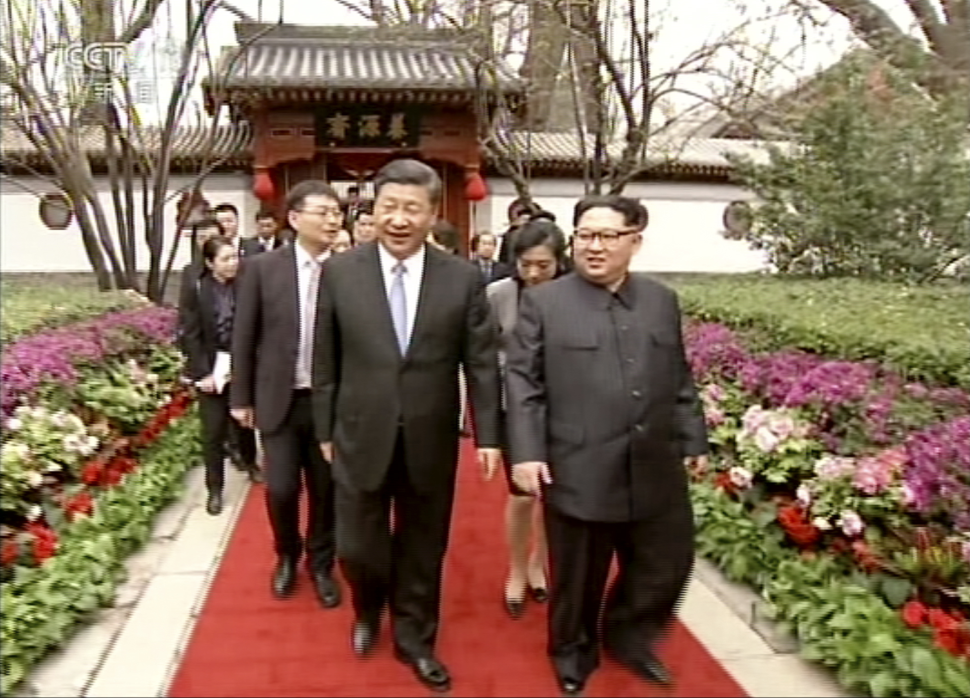 Kim Jong Un and Xi Jinping walk together in Beijing (CCTV via AP Video)