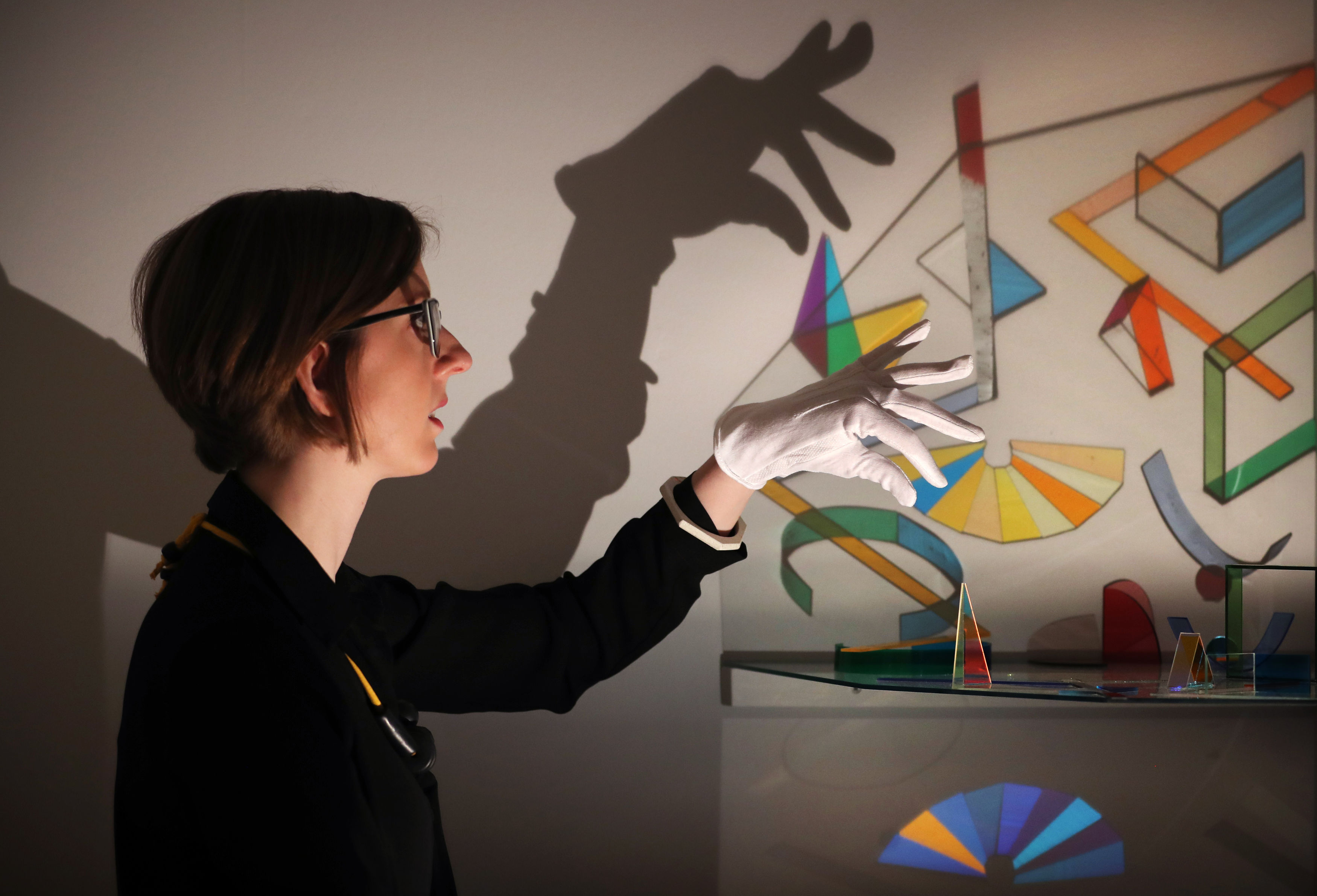 Bryony Windsor, head of exhibitions, takes a closer look at a glass and light sculpture titled Alter by artist Helen Maurer which features in a new exhibition Art of Glass at the National Museum of Scotland in Edinburgh (Jane Barlow/PA)