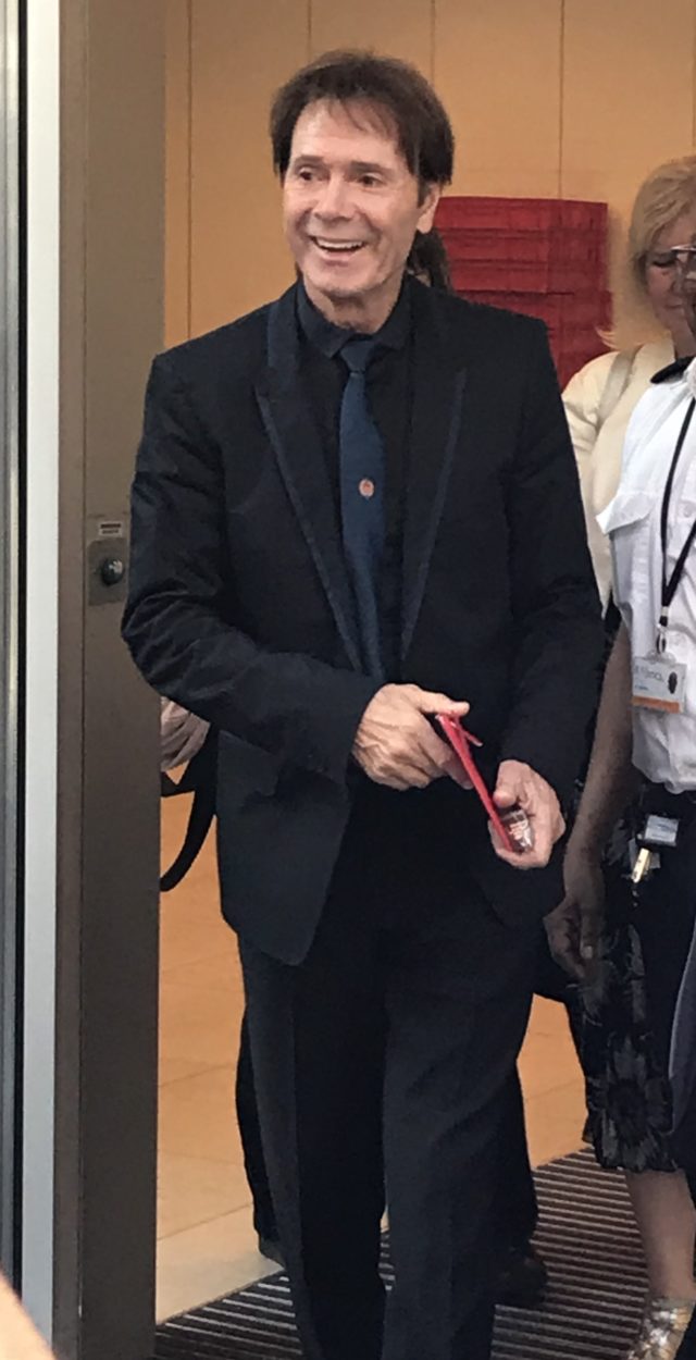 Sir Cliff Richard smiles to fans as he leaves court after the fifth day of his case against the BBC over its coverage of a police raid on his home in 2014 (Sian Harrison/PA)