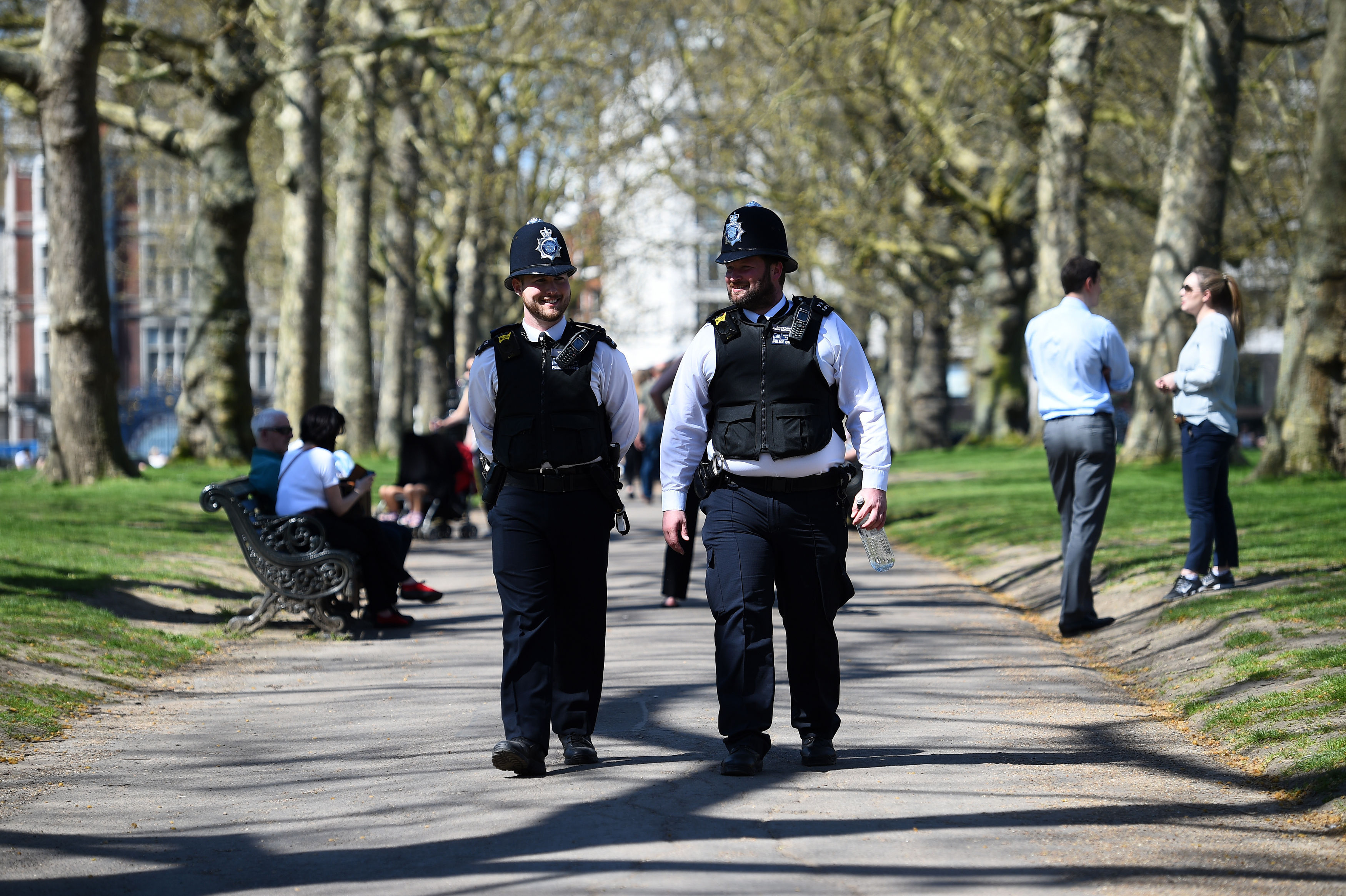 Two police officers walk through Green Park in the sunshine (Kirsty O'Connor/PA)