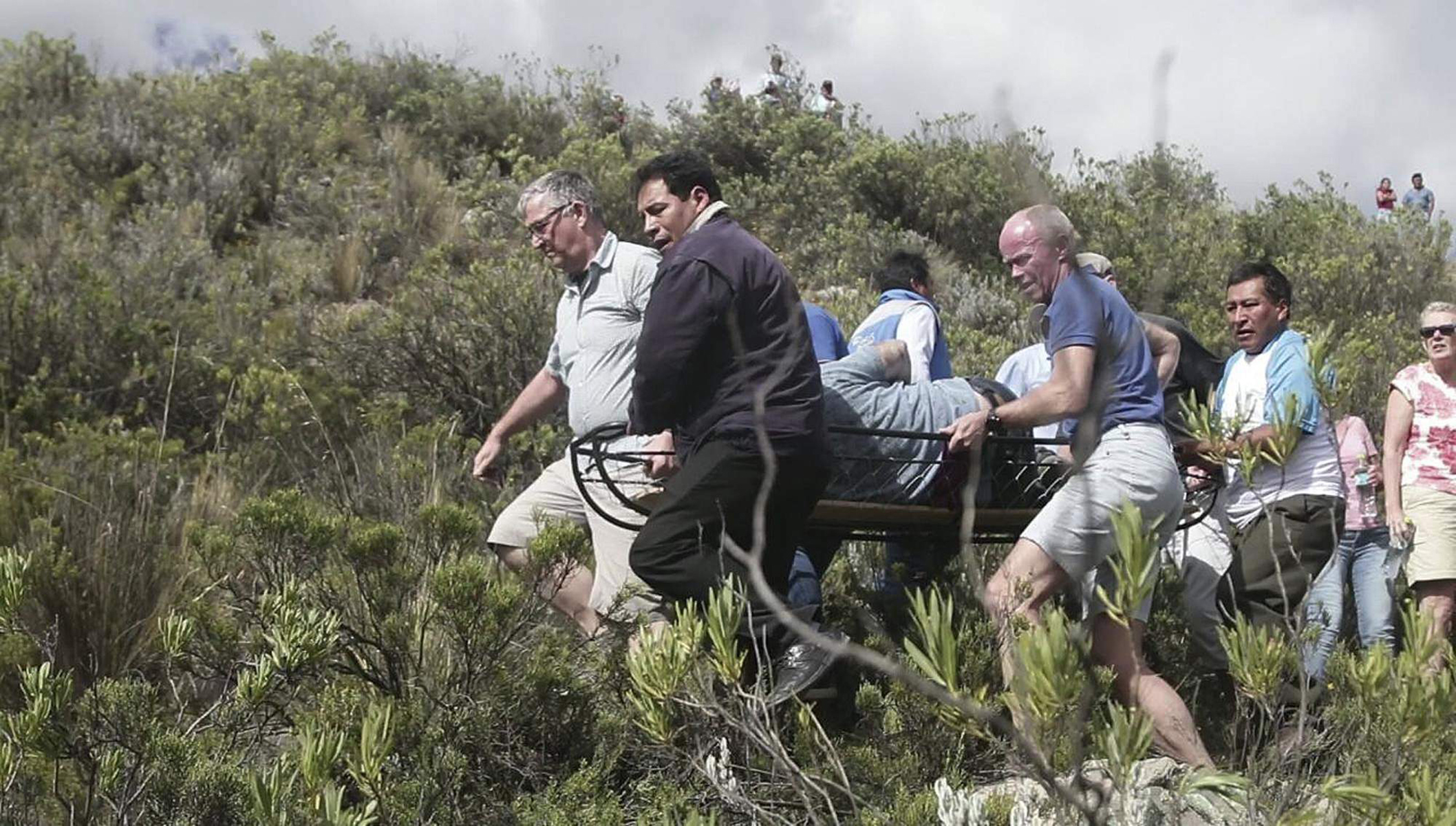 German tourists and local residents at the site of a minibus crash in Peru (Andina News Agency via AP)