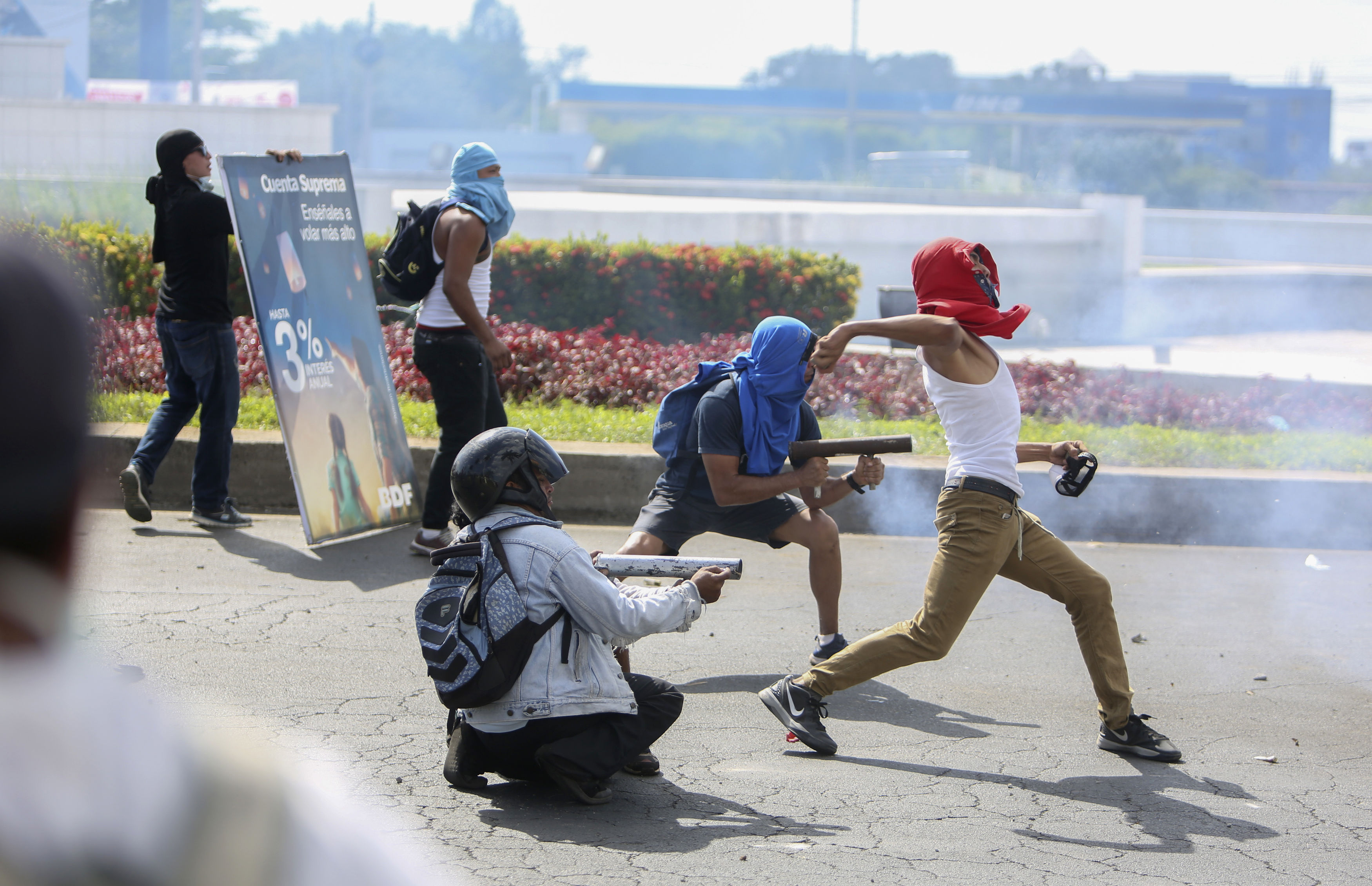 Masked protesters during a third day of violent clashes in Nicaragua (Alfredo Zuniga/AP)