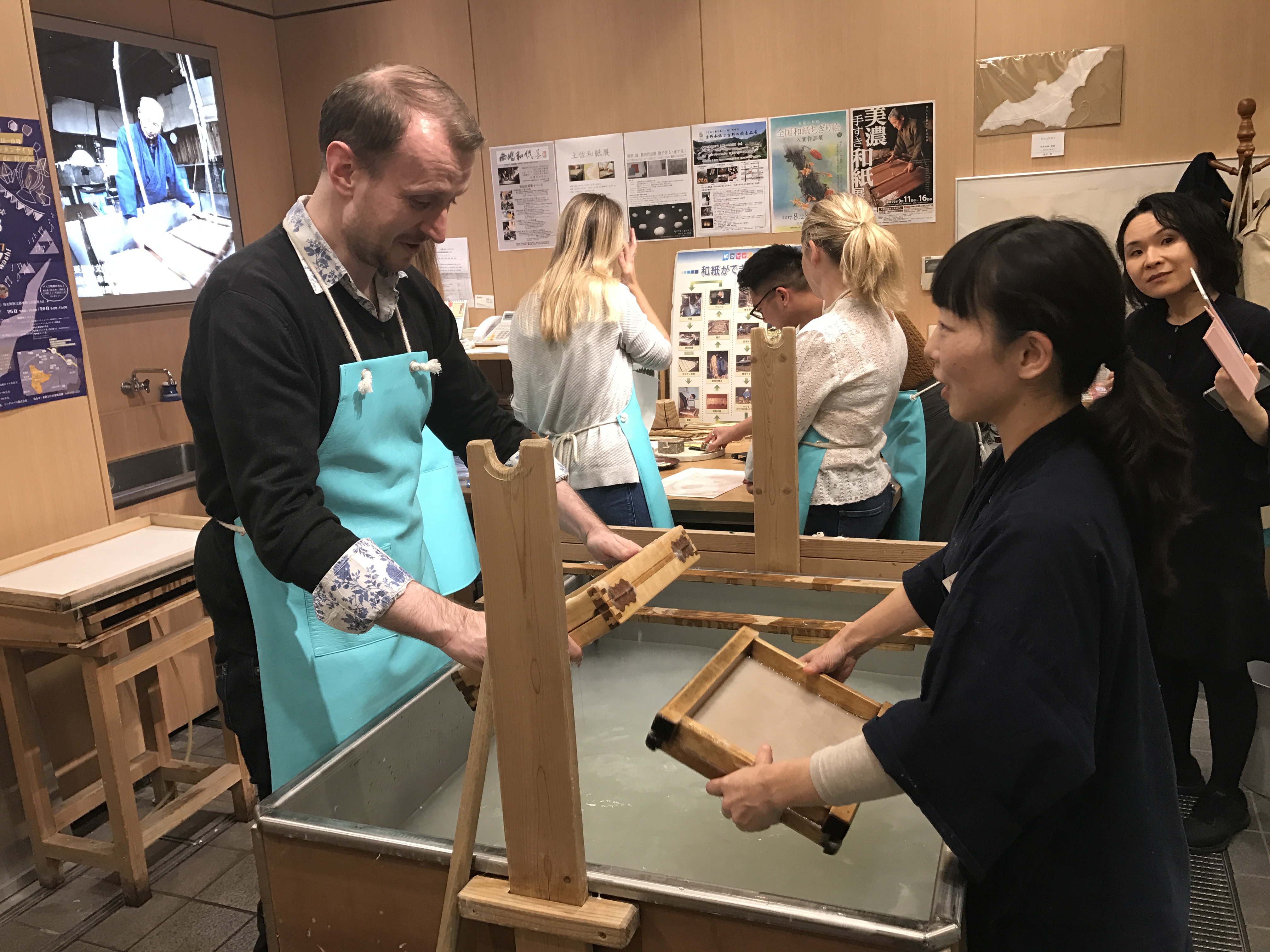 Damon Smith follows the instructions of a tutor at the Washi Experience Studio at Ozu Washi (Michiko Fujikawa/PA)