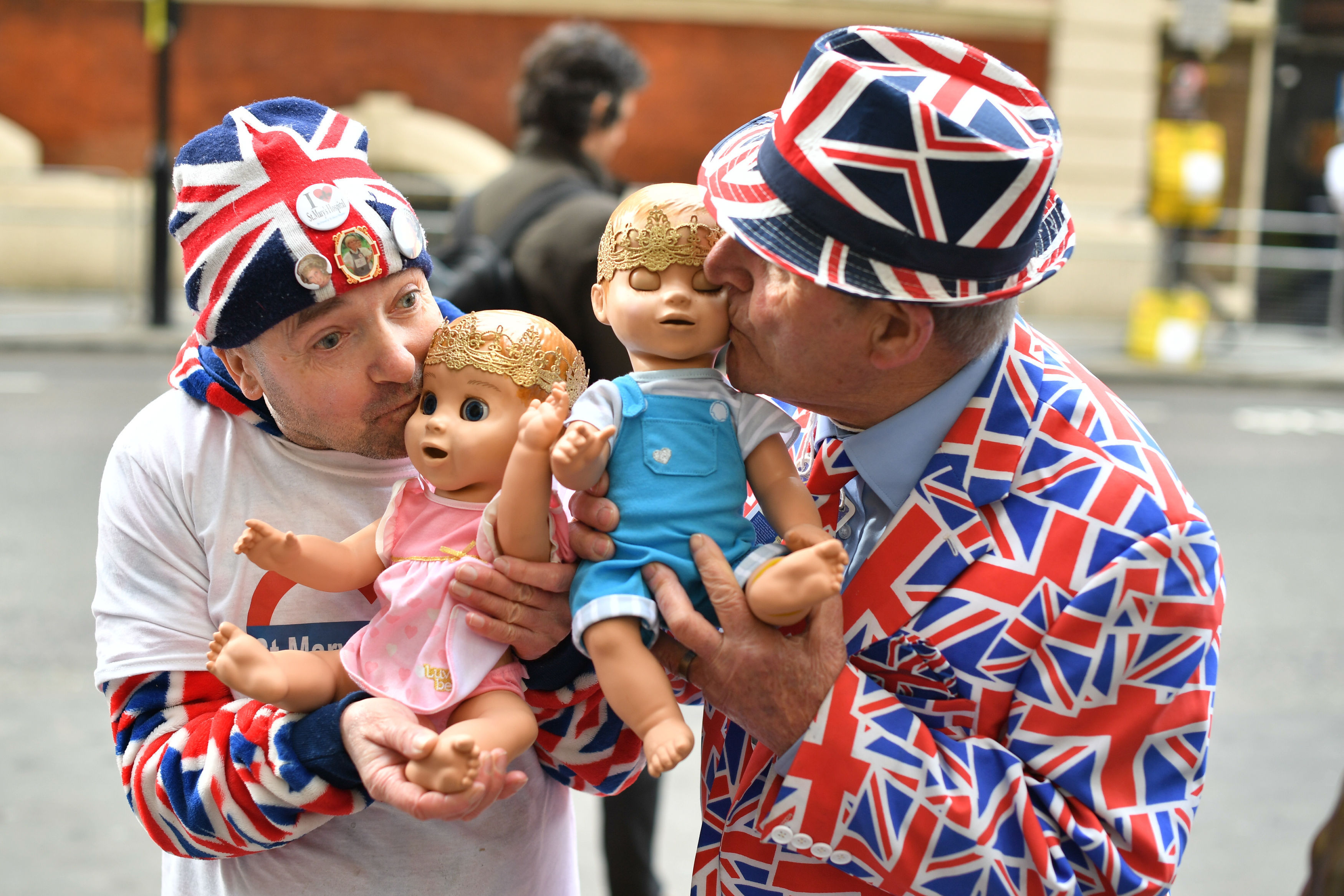 Royal fans John Loughrey (left) and Terry Hutt hold dolls outside St Mary's Hospital (Dominic Lipinski/PA)