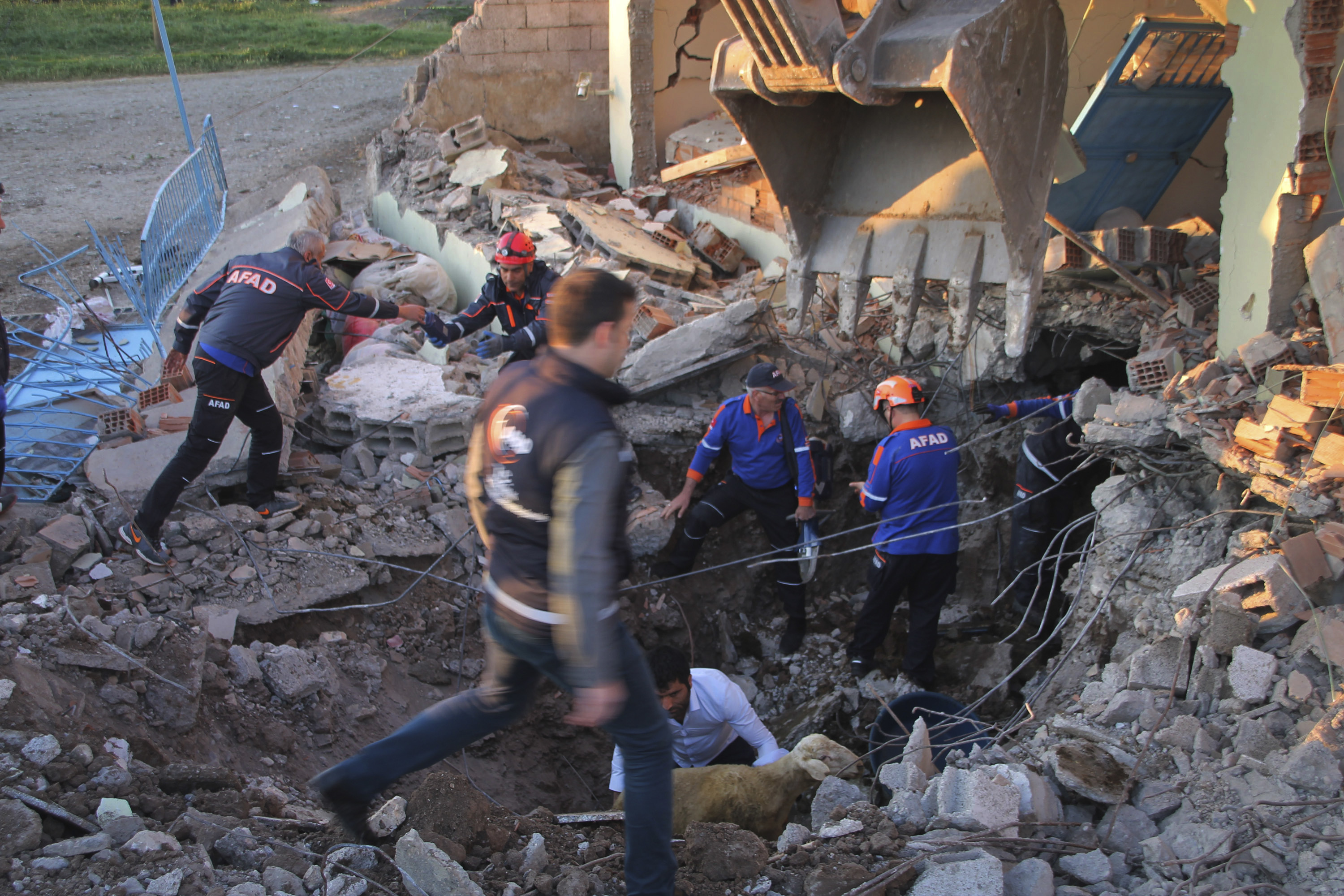 Emergency services search the rubble of houses destroyed by the earthquake in south-eastern Turkey (Mahir Alan/Depo Photos via AP)
