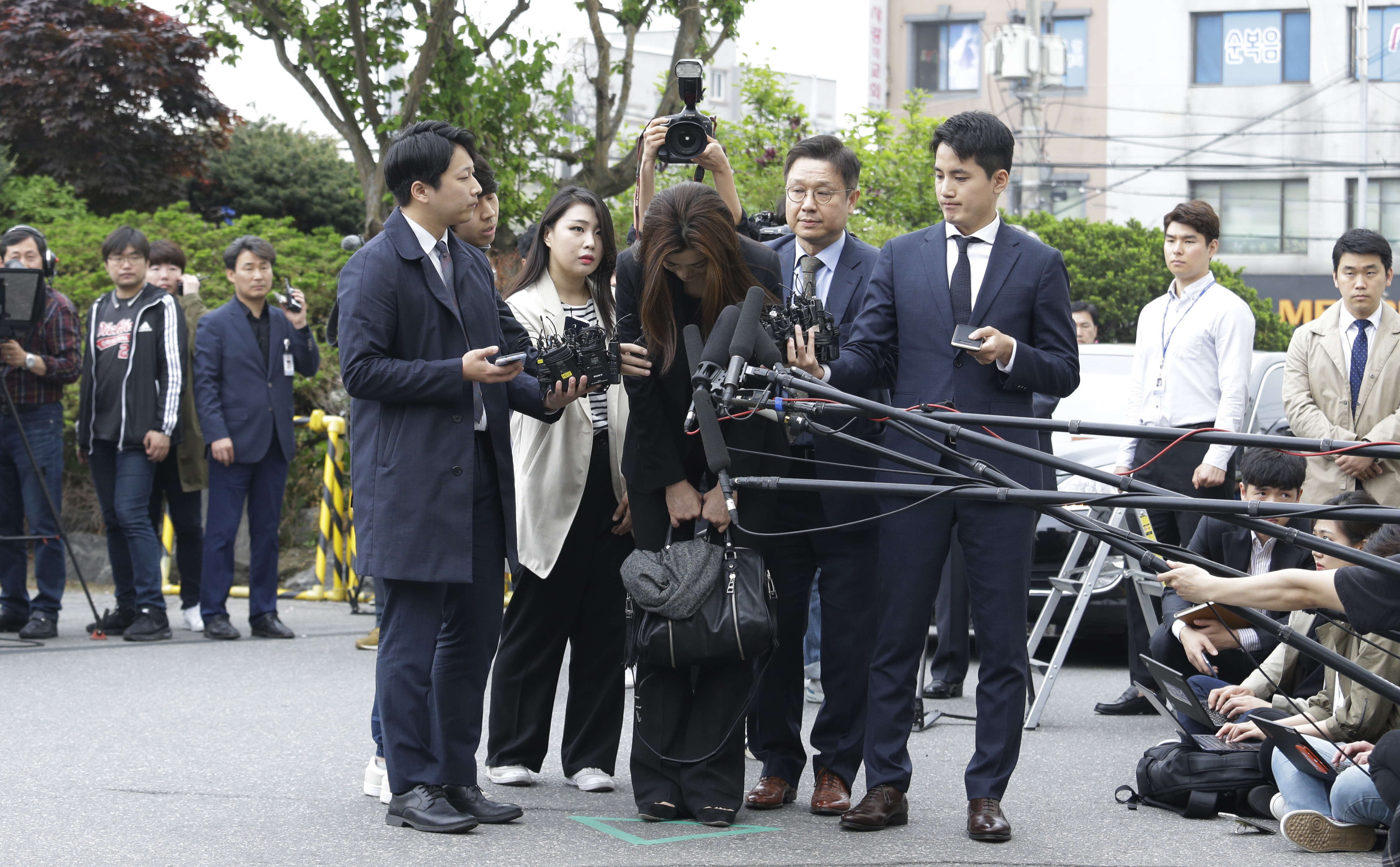 Cho Hyun-min bows as she arrives at a police station in Seoul (Ahn Young-joon/AP)