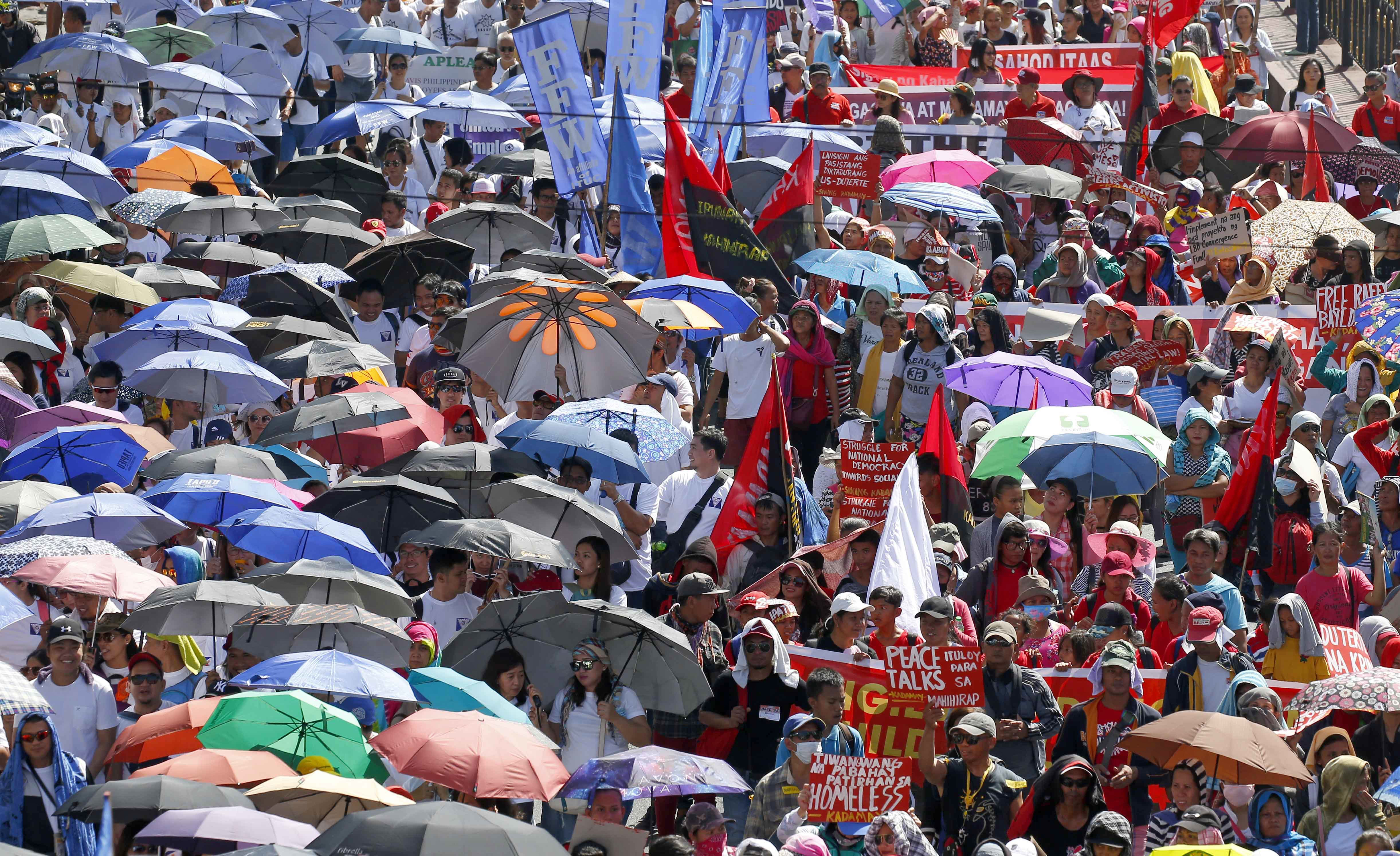 Protesters march towards the Presidential Palace (Bullit Marquez/AP)