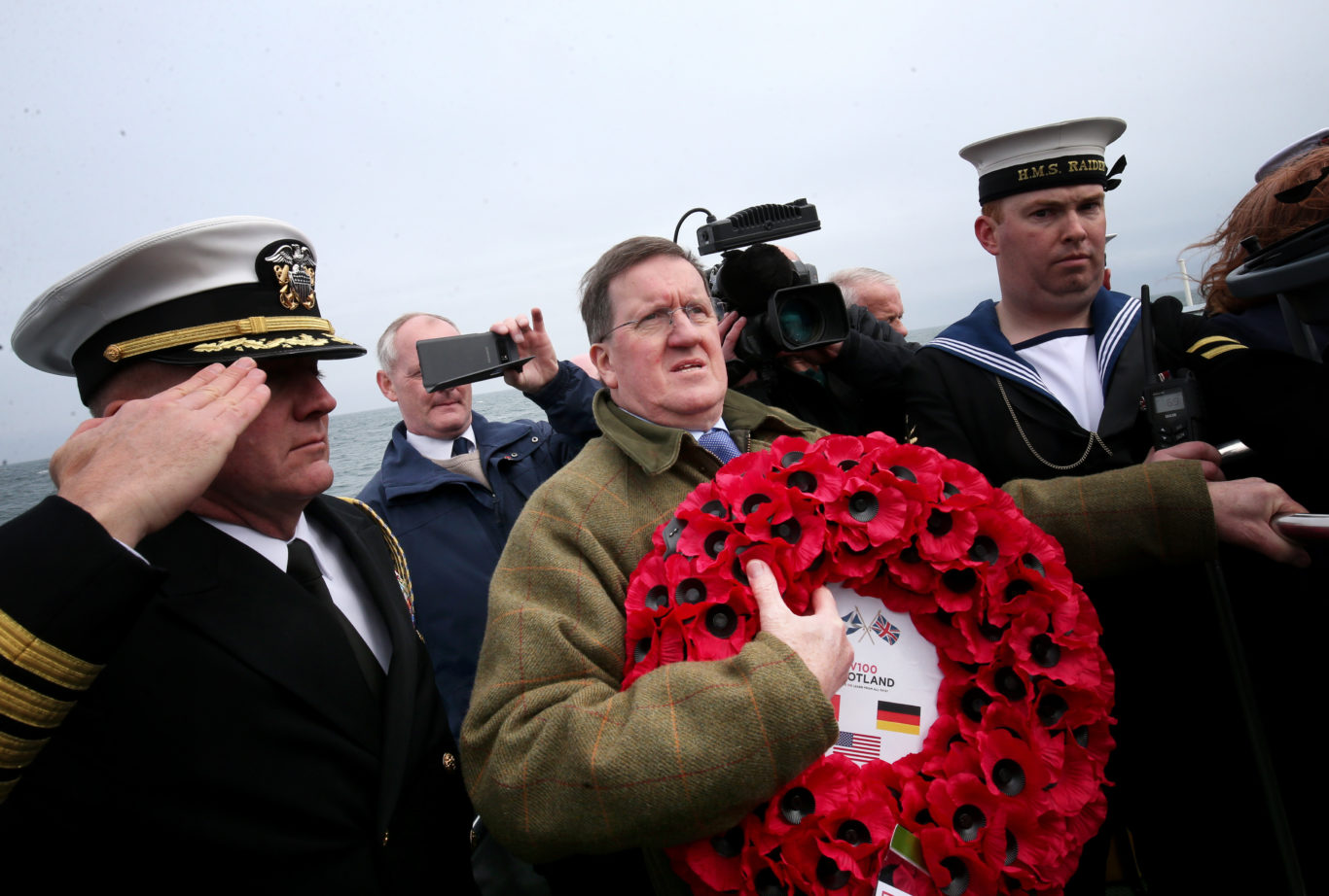 Lord George Robertson holds a wreath prior to throwing it in the sea close to the wreck of SS Tuscania (Jane Barlow/PA)