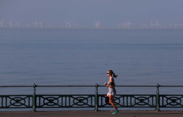 A jogger on Brighton seafront as the early May Bank Holiday Monday is forecast to be the hottest since records began (Steve Parsons/PA)