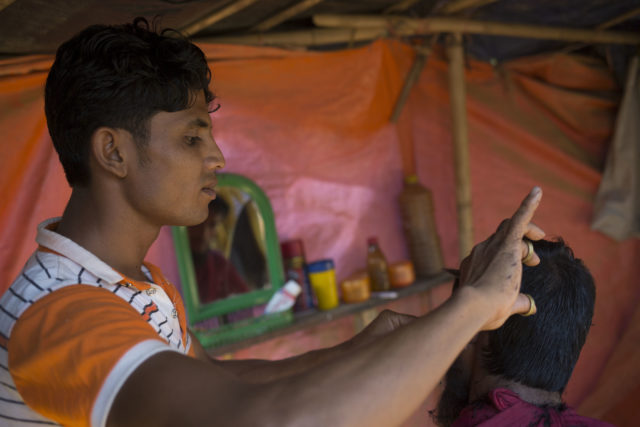 Mohammed Sayed, 20, a barber in Myanmar, who has continued cutting hair in the camps (AJ Ghani/British Red Cross)