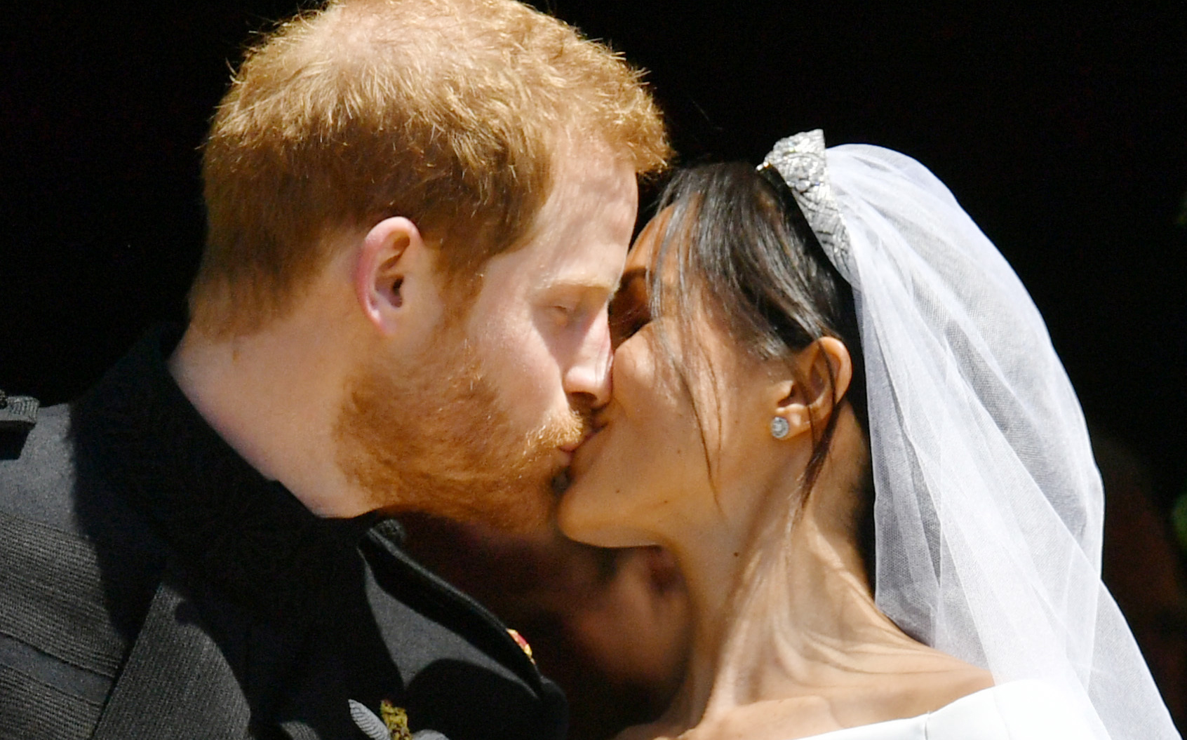 Prince Harry and Meghan Markle kiss on the steps of St George's Chapel in Windsor Castle after their wedding (Ben Birchall/PA)