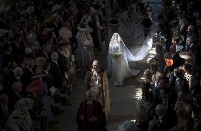 Meghan walks down the aisle lit by shafts of light (Danny Lawson/PA)