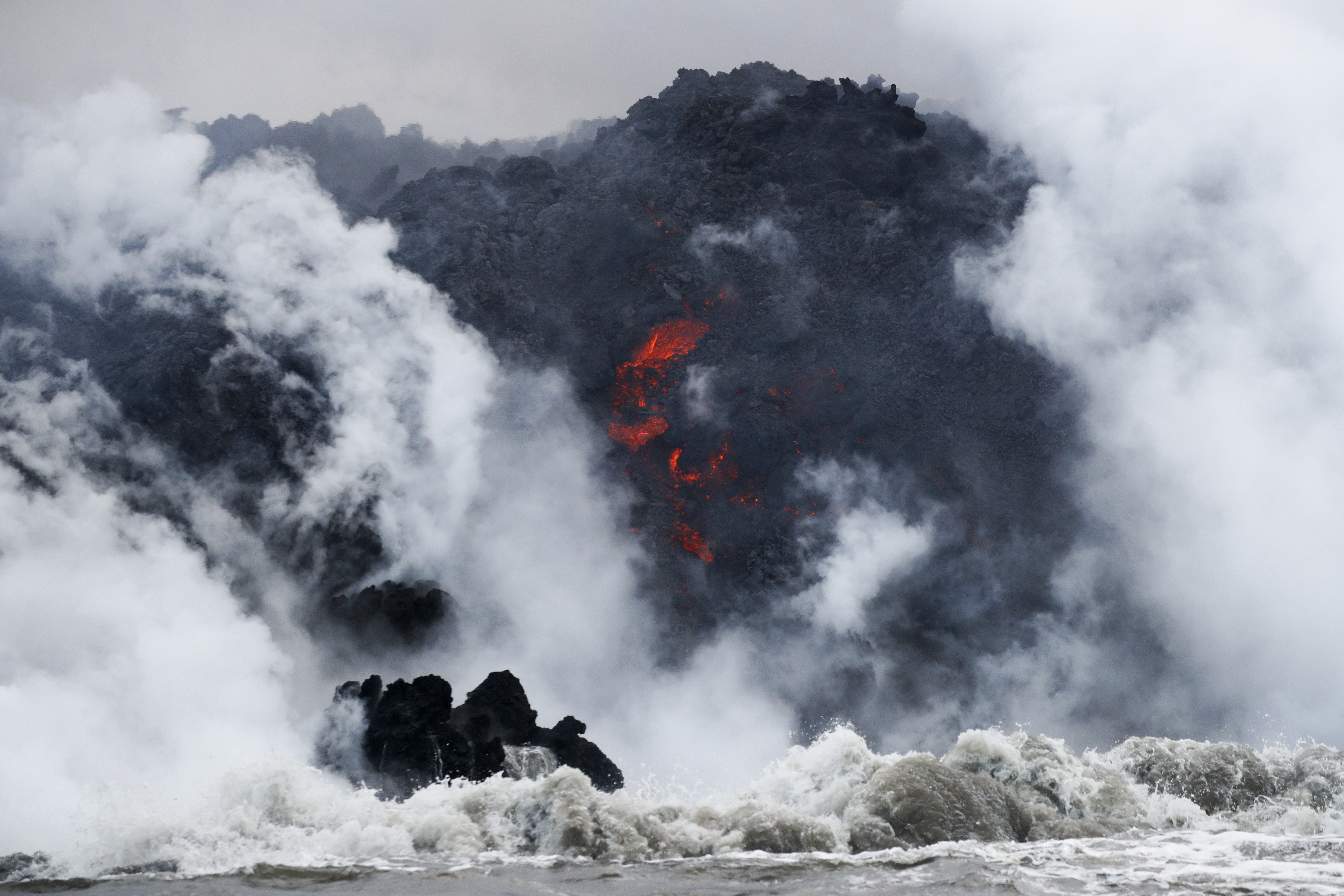 Lava flows into the ocean near Pahoa (Jae C Hong/AP)