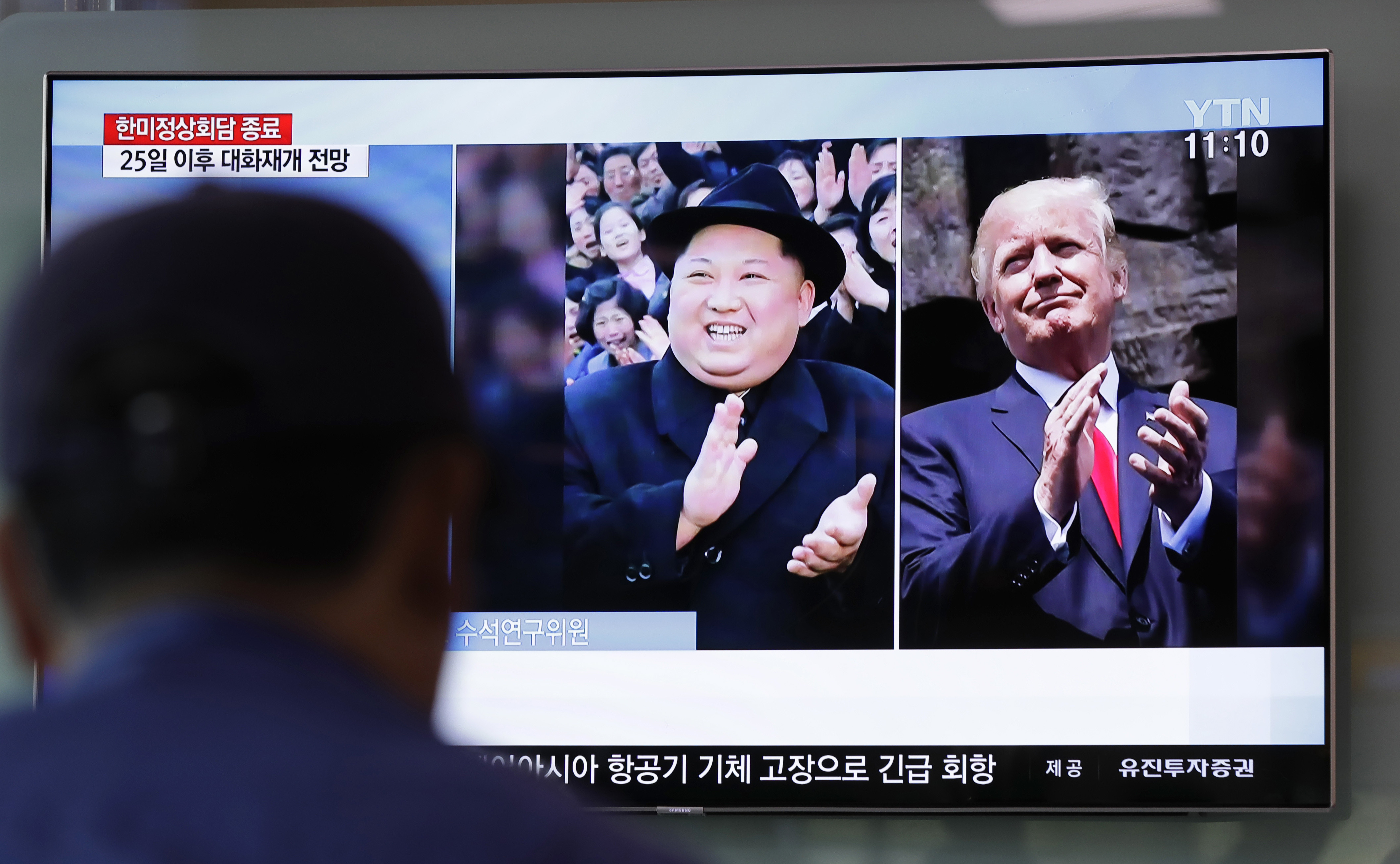A TV screen showing Kim Jong Un and Donald Trump
