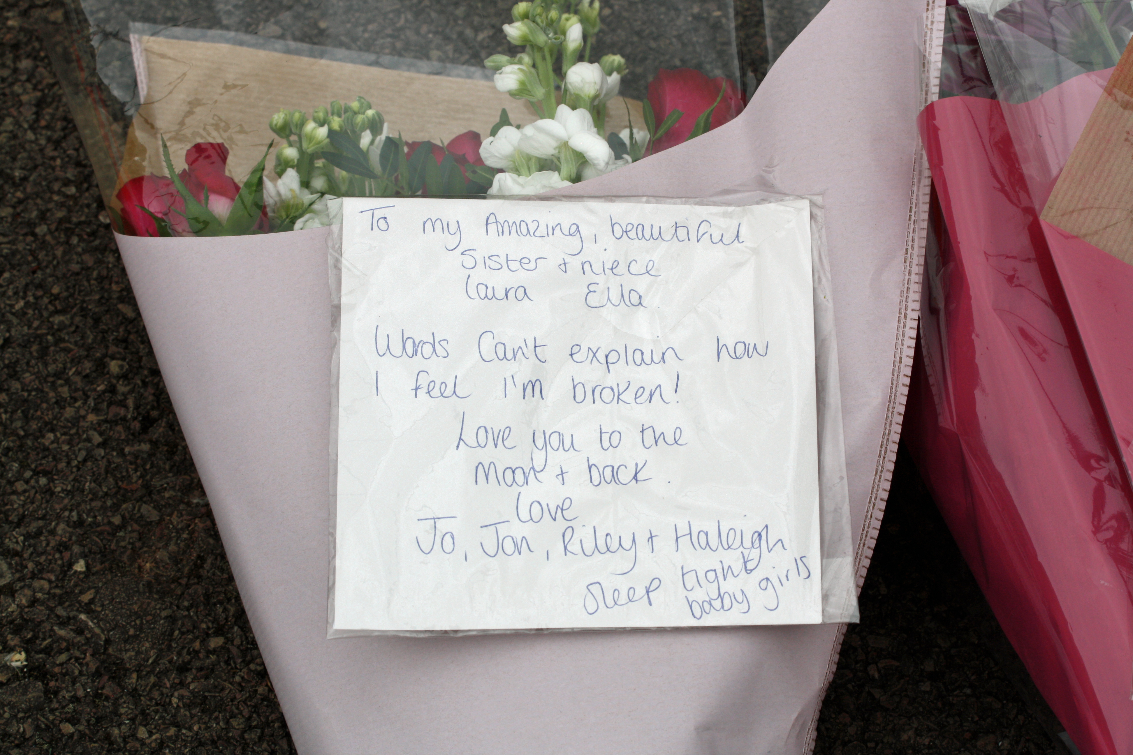 The sister of 31-year-old Laura Mortimer writes of here loss in a floral tribute left at Dexter Way in Gloucster (Rod Minchin/PA)