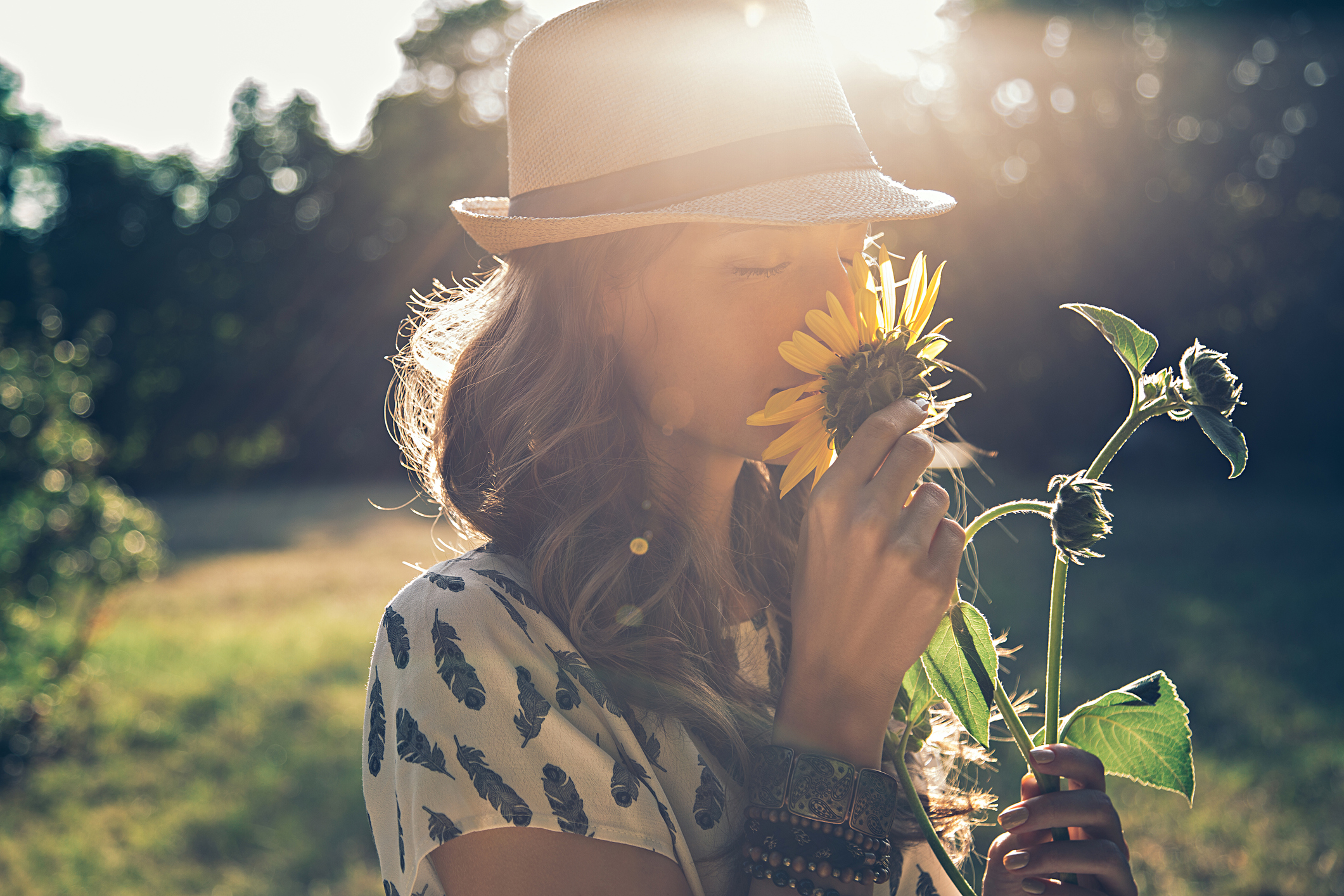 Woman smells sunflower