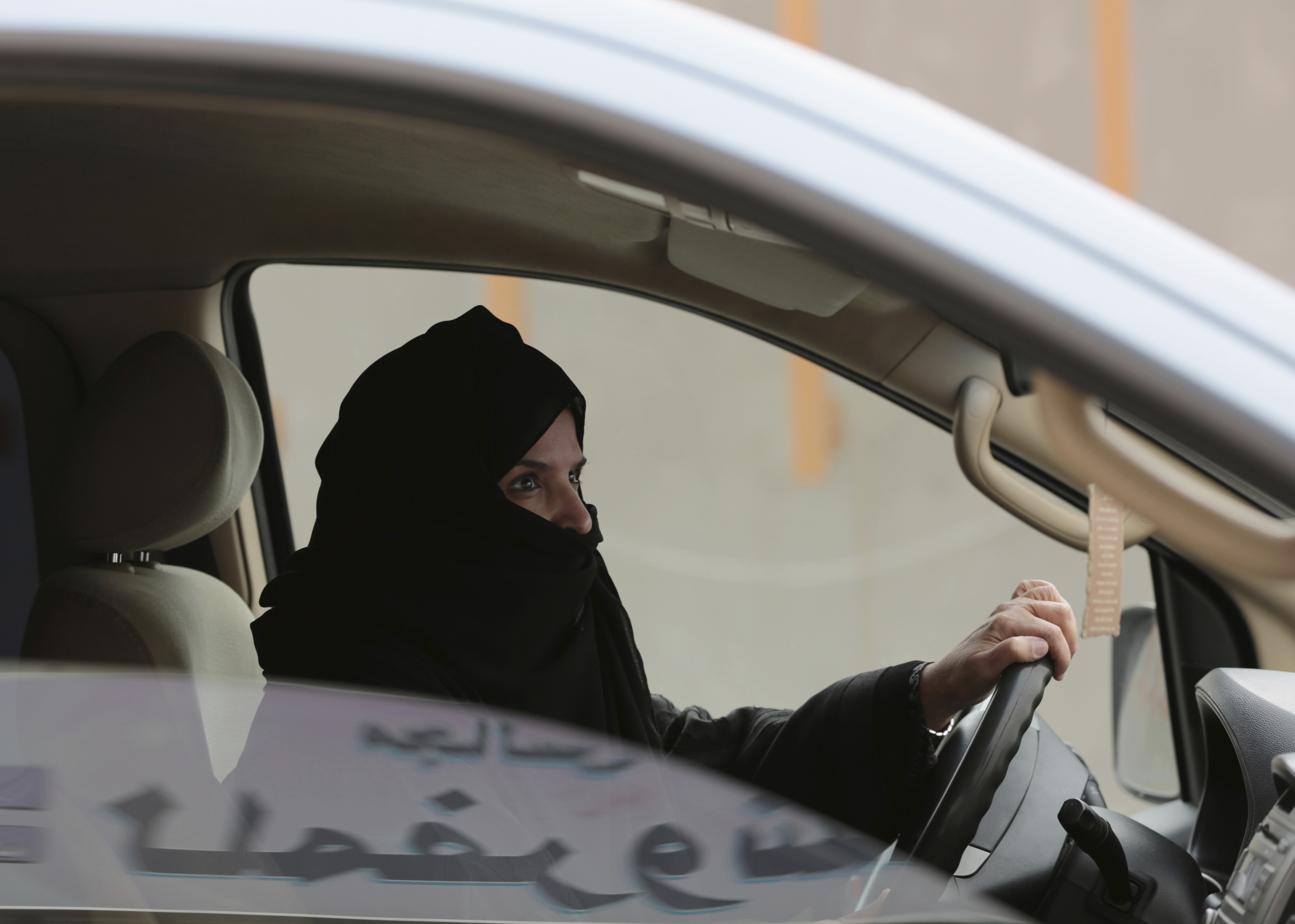 Aziza al-Yousef drives a car in Riyadh as part of a campaign to defy Saudi Arabia's ban on women driving