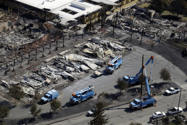 PG&E crews work on restoring power lines after a wildfire in Santa Rosa, California, last October (Marcio Jose Sanchez/AP)