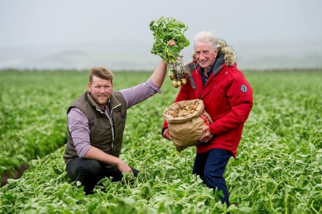 Farmer David Young with Jamie McCoo and his batch of potatoes (Peter Sandground/PA)