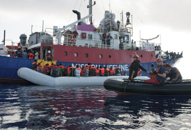 The ship operated by Mission Lifeline rescues migrants from a rubber boat in the Mediterranean Sea