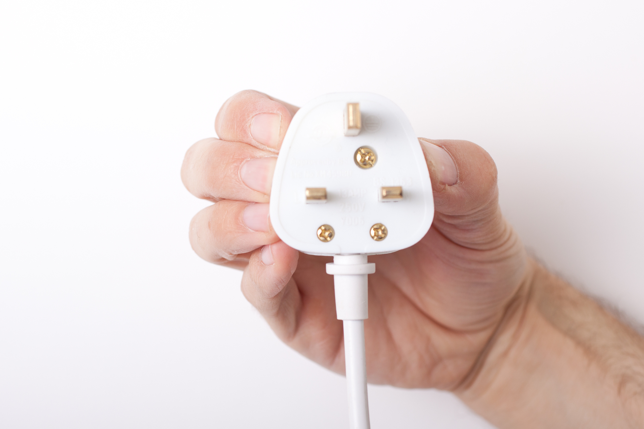 Male hand holding an electrical plug