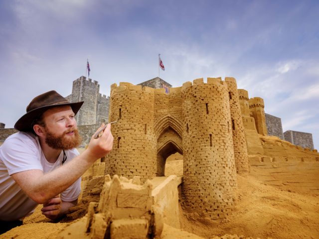 Sand sculptor Jamie Wardley describes making the castle as a 'once in a lifetime experience' (English Heritage/PA)