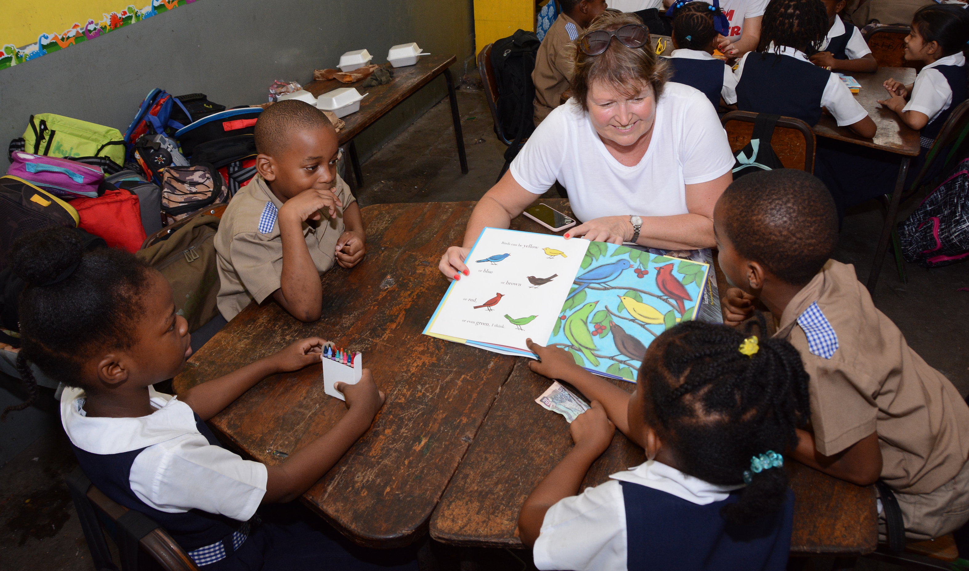 Hannah helps pupils read on a reading road trip excursion (Sandals Resorts/PA)
