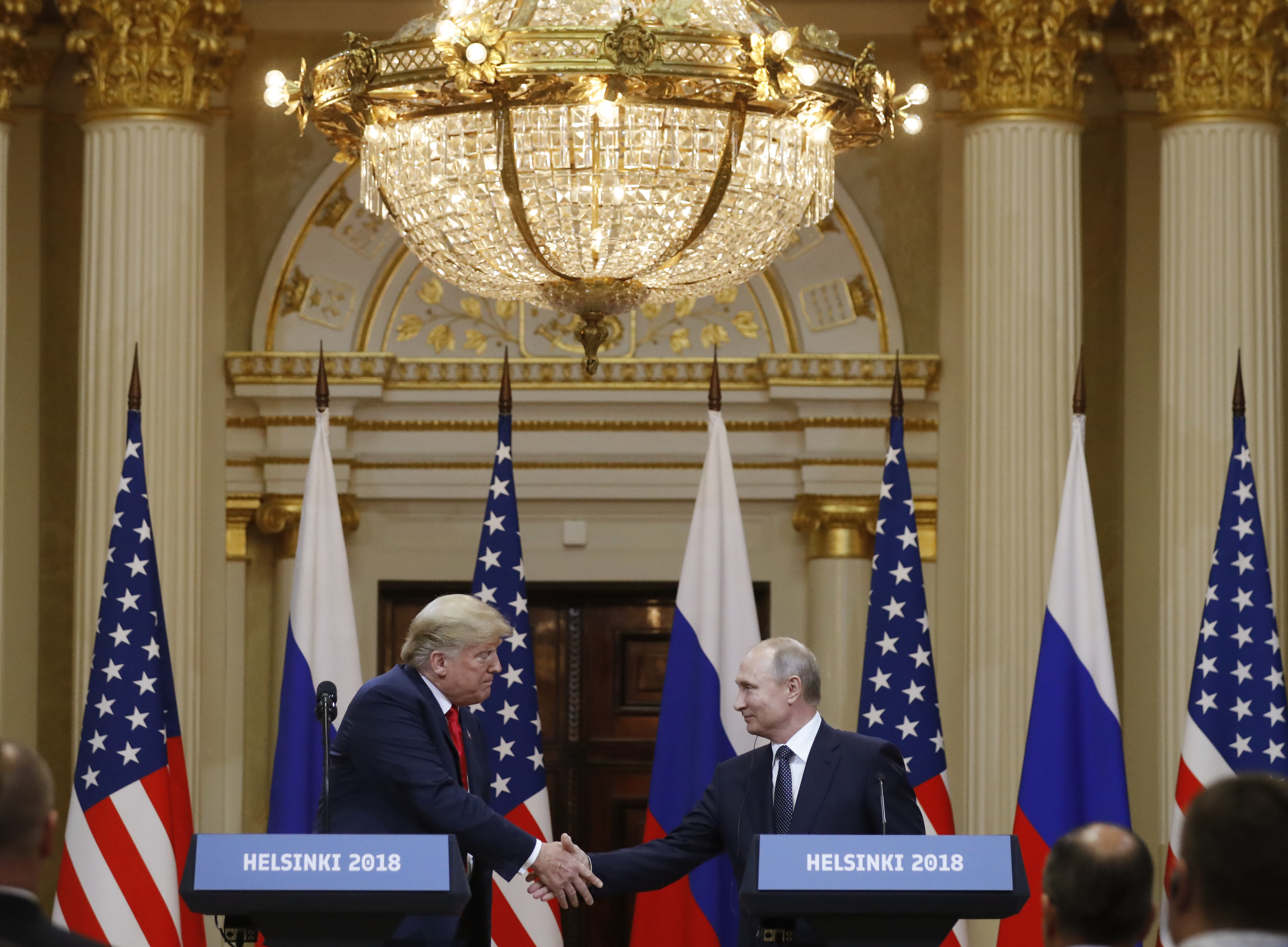 Donald Trump shakes hands with Vladimir Putin at the Presidential Palace in Helsinki