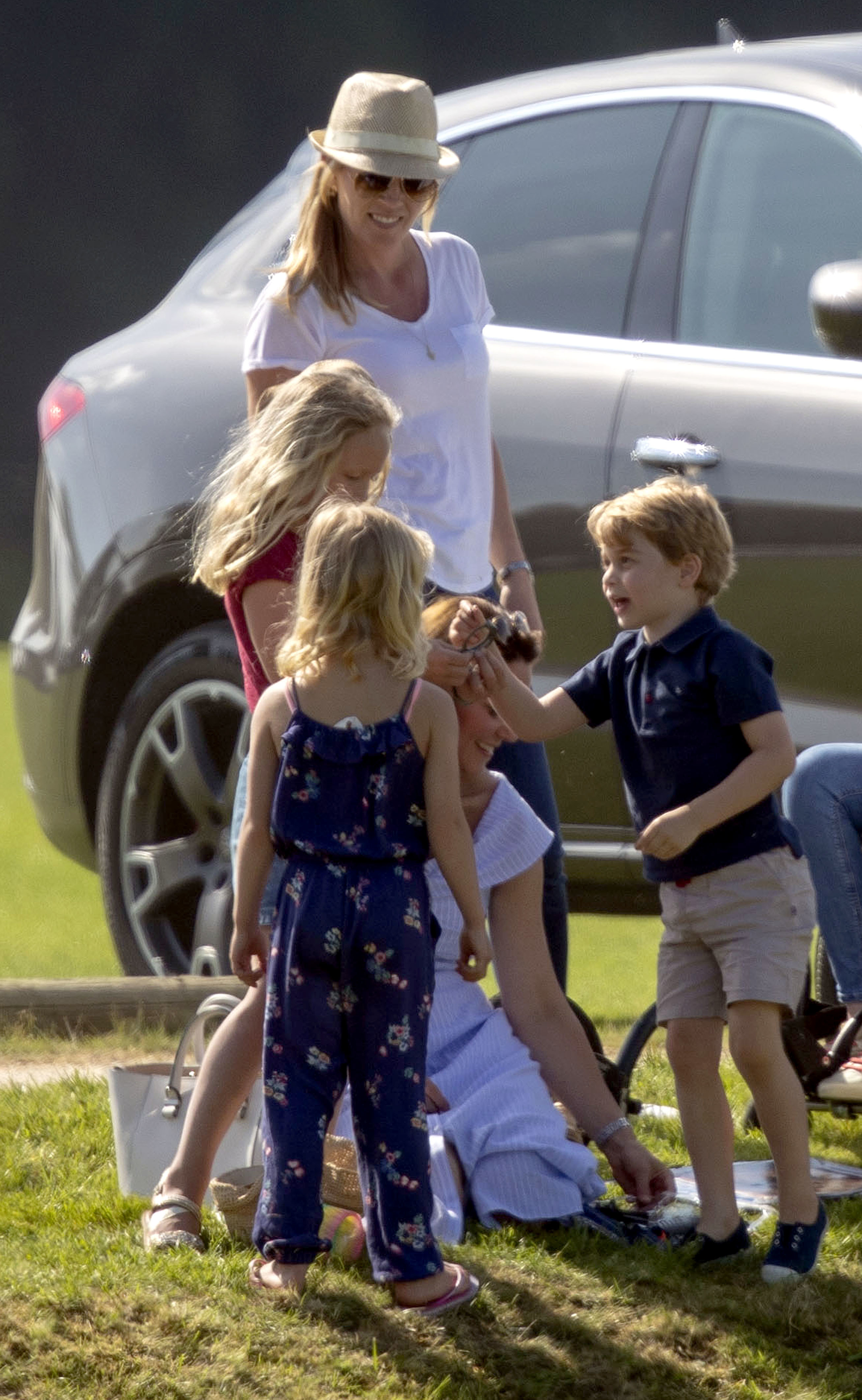 The Duchess of Cambridge (sitting) with Prince George and Autumn Phillips and her children, Savannah and Isla, as her husband the Duke of Cambridge takes part in the Maserati Royal Charity Polo Trophy at the Beaufort Polo Club, Downfarm House, Westonbirt, Tetbury