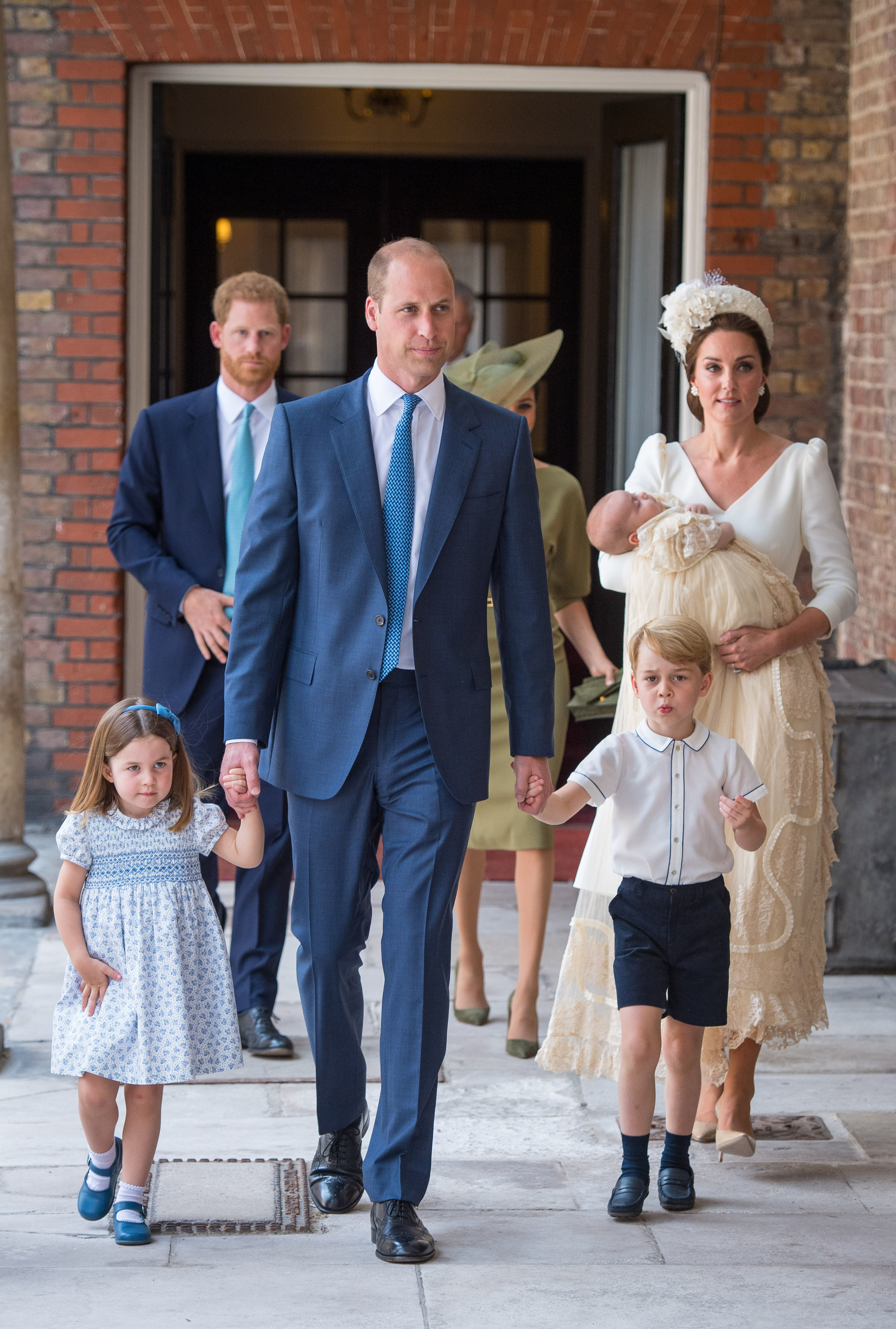 Princess Charlotte and Prince George hold the hands of their father, the Duke of Cambridge, as they arrive at the Chapel Royal, St James's Palace, London for the christening of their brother, Prince Louis, who is being carried by their mother, the Duchess of Cambridge