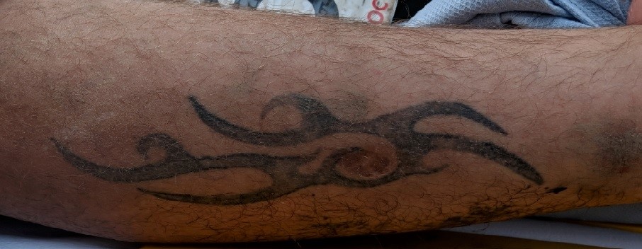 The man's leg tattoo