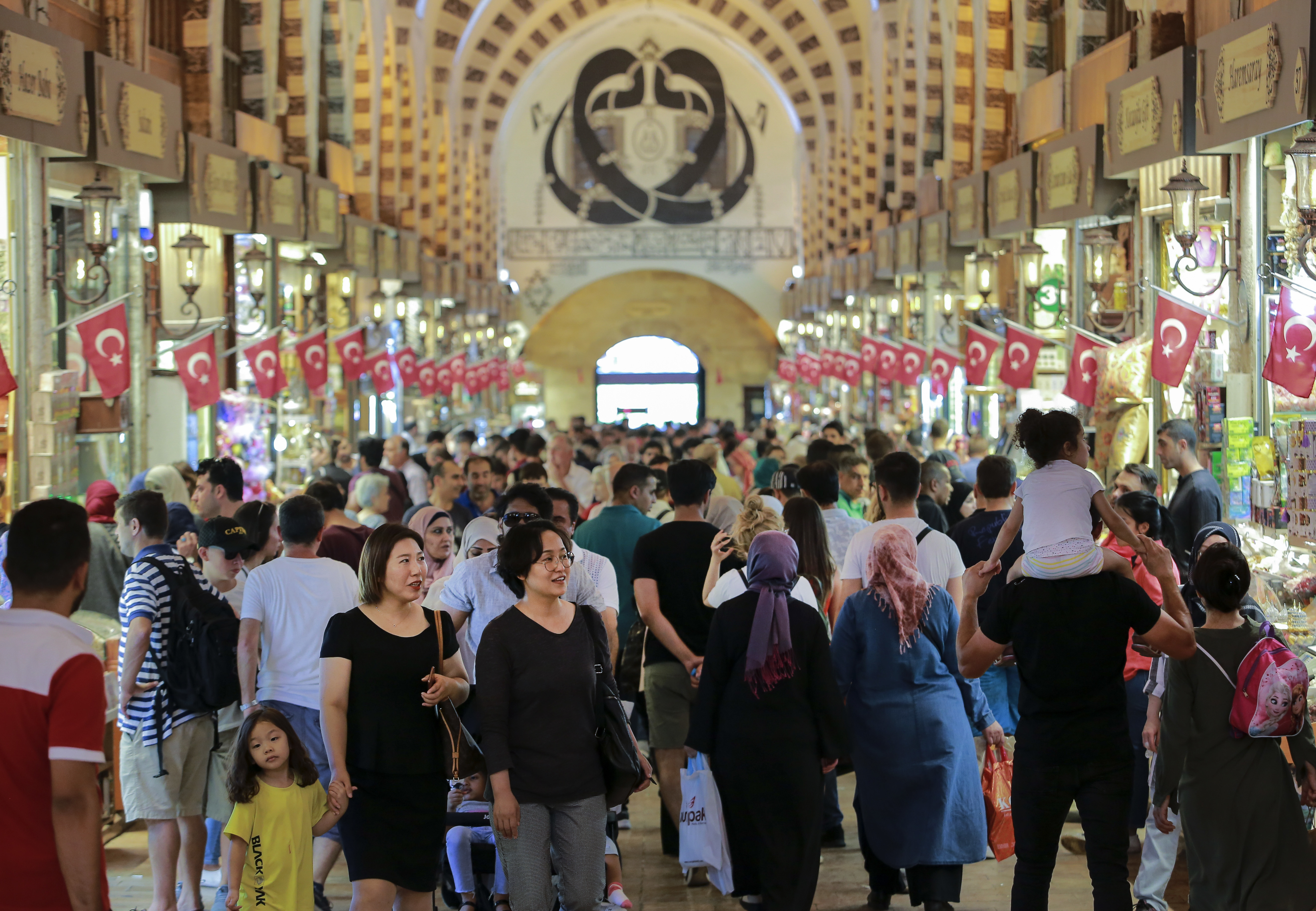 People walk in a market in Istanbul