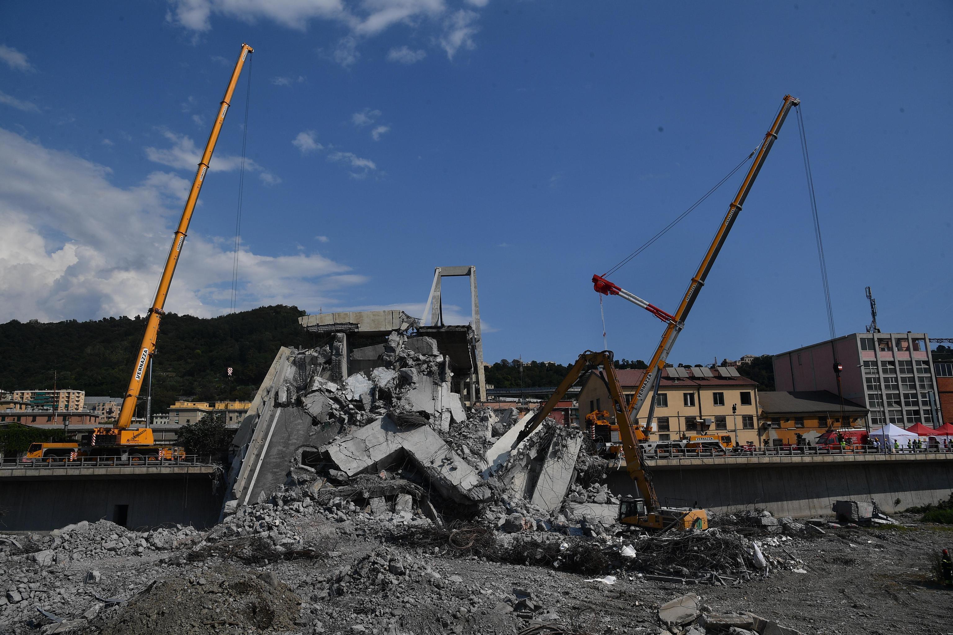Debris is removed from the collapsed Morandi motorway bridge in Genoa