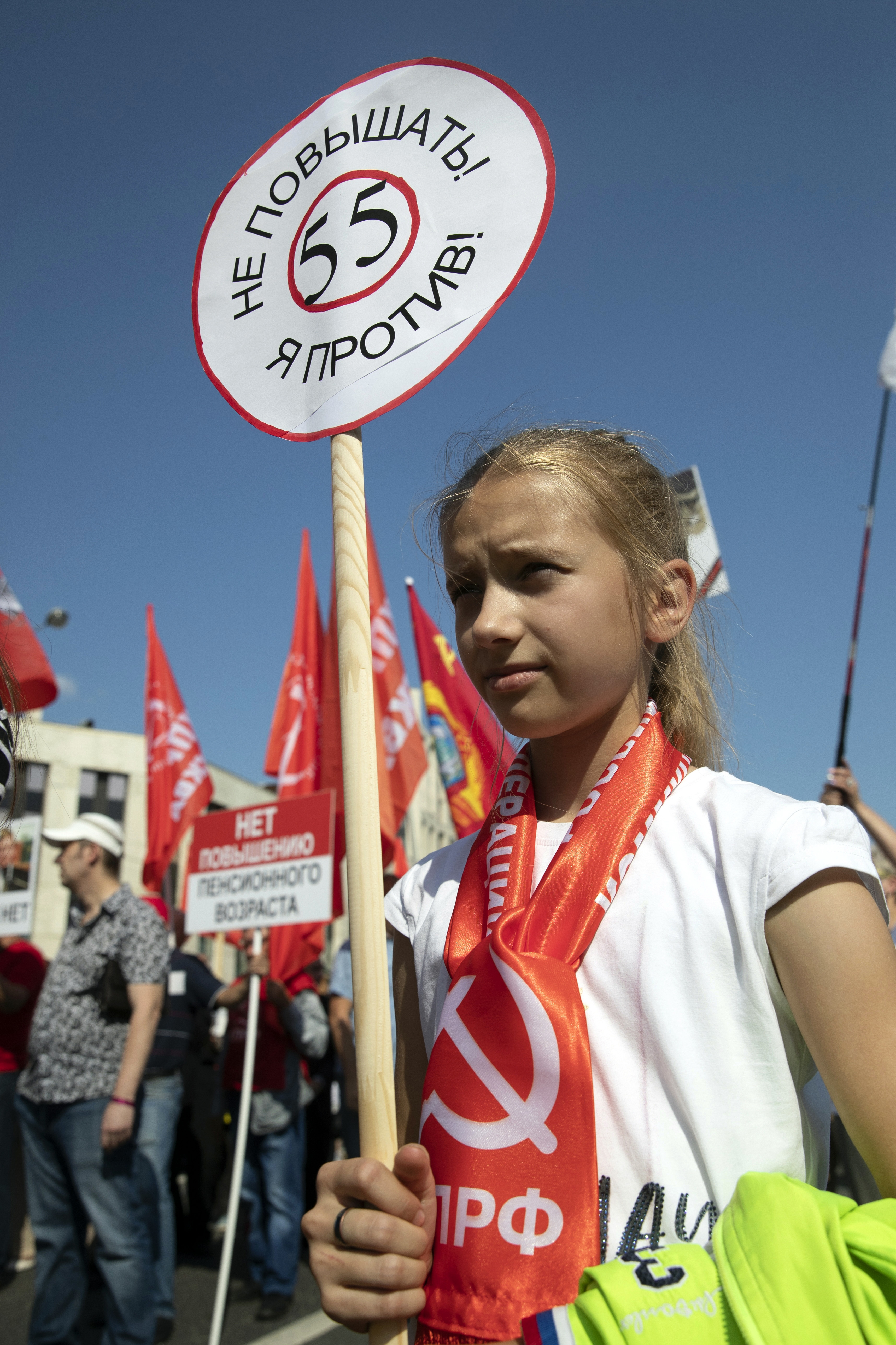A girl holds a banner reading "No to the raise! I'm against!" during the Communist Party rally protesting against retirement age hikes in Moscow