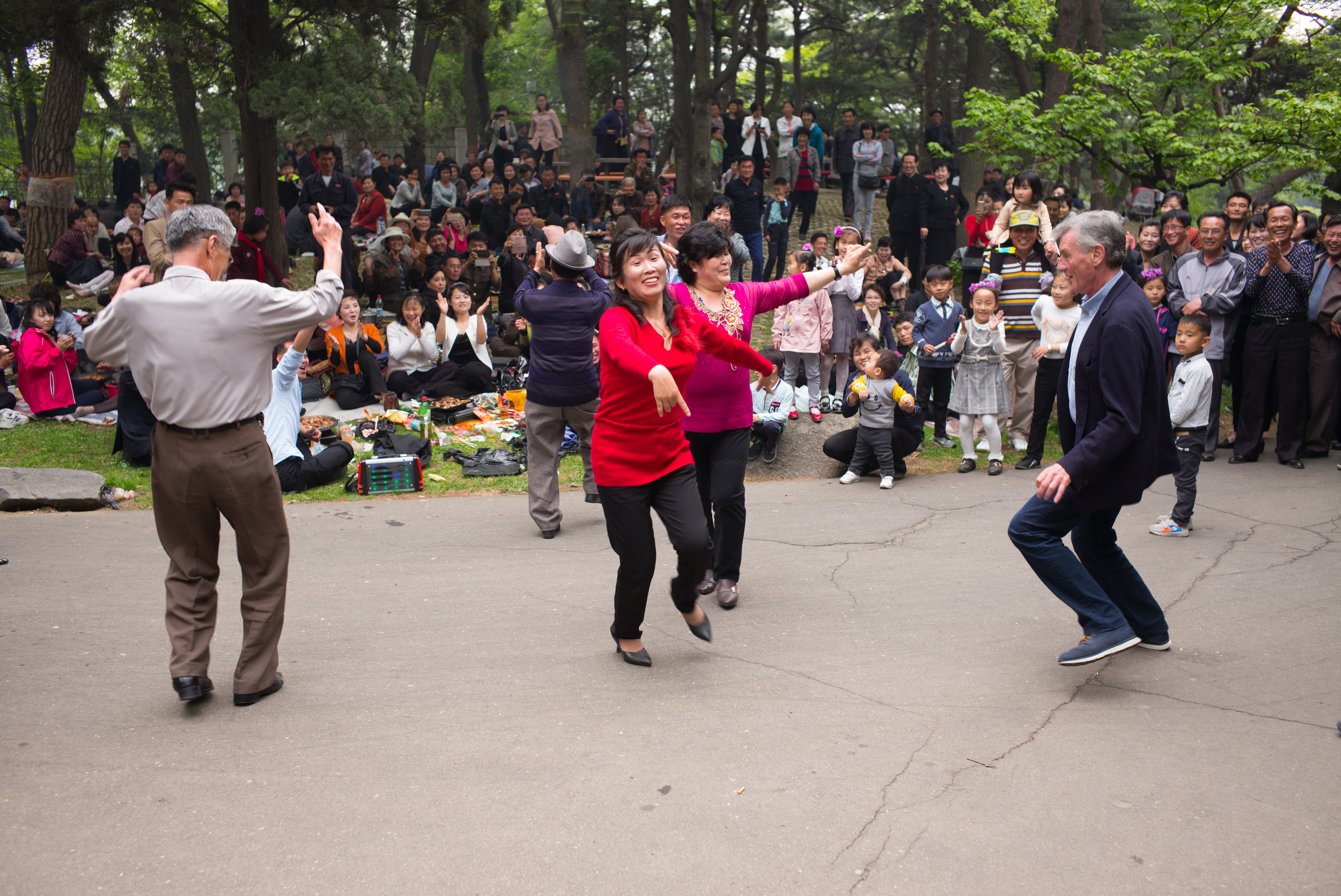 Michael Palin dancing with North Korean residents at the May Day parade (ITN Productions/Channel 5/PA)