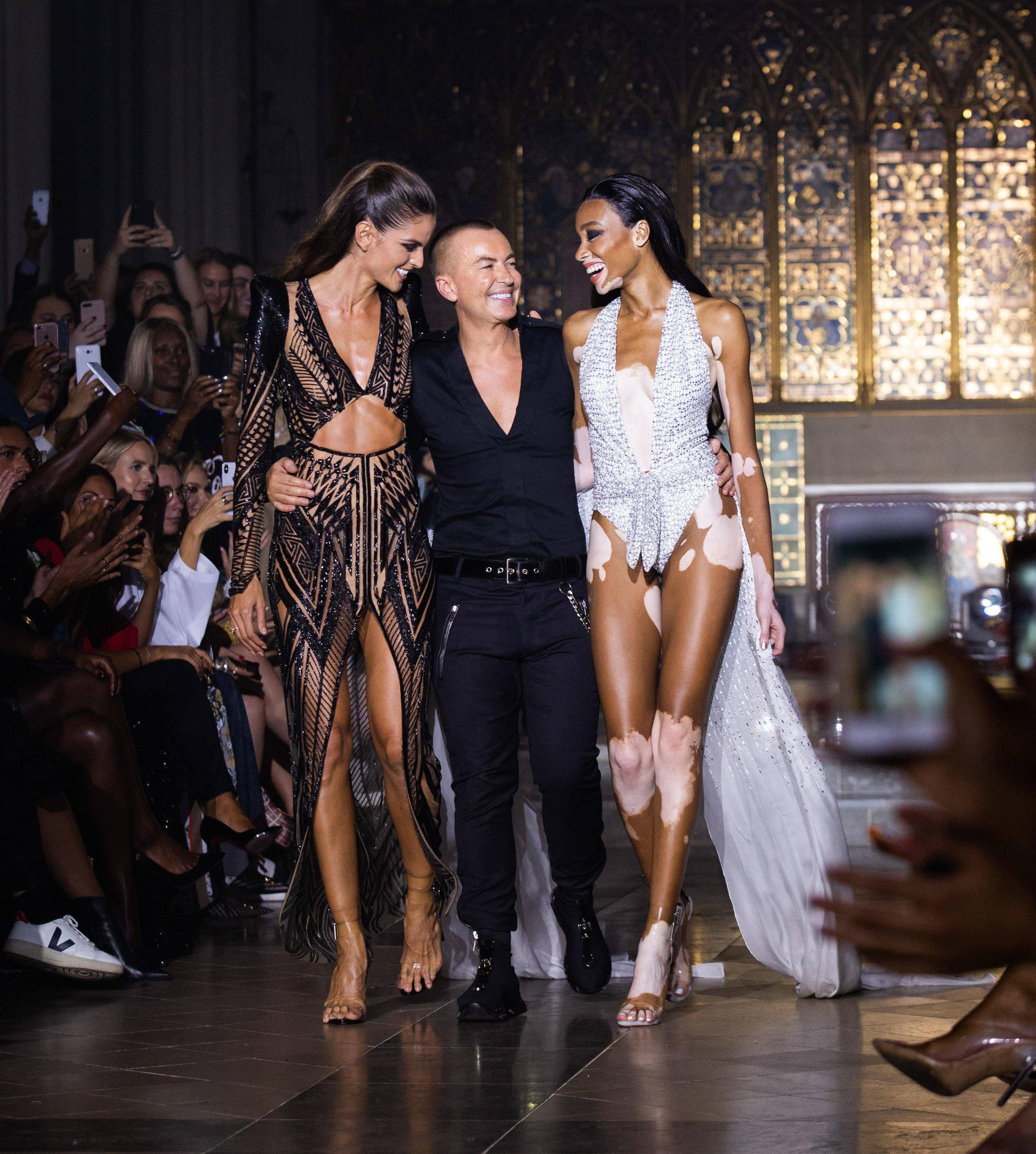 Model Winnie Harlow (right) with Julien Macdonald on the catwalk during his London Fashion Week show held at St John & Otilde's Hyde Park, London.