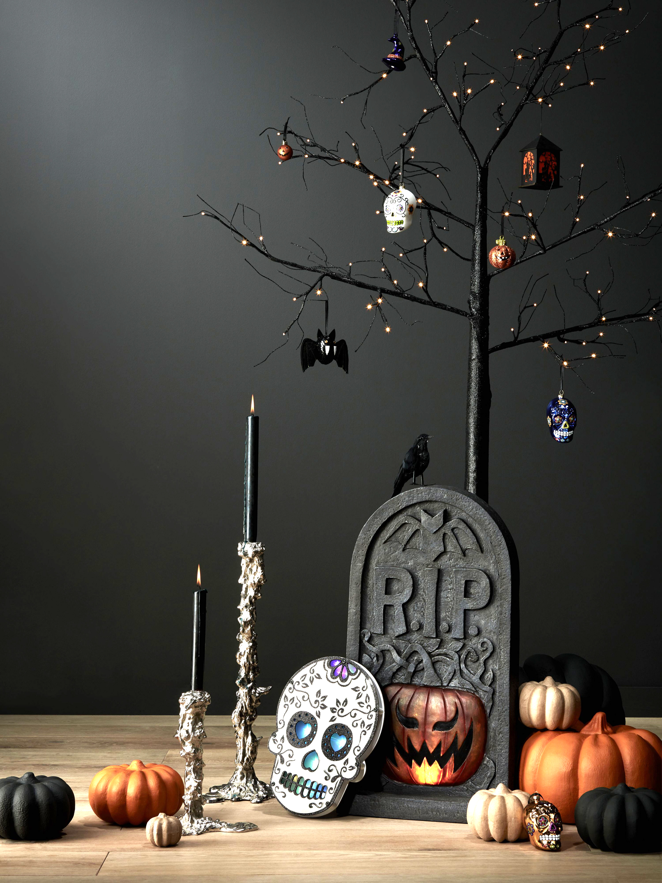 Pre-lit Halloween Tree, Black, 60cm, £22; Decorative Glass Skulls, pack of 4, £18; Halloween Sequin Bat Hanging Decoration, Black, £2.50; Pols Potten Drip Candlestock, Large £72 and XXL, £150; Premier Decorations Lit Tombstone With Sound (60cm) £40; Premier Decorations Day of the Dead Plaque (30cm) £12, all John Lewis (John Lewis/PA)