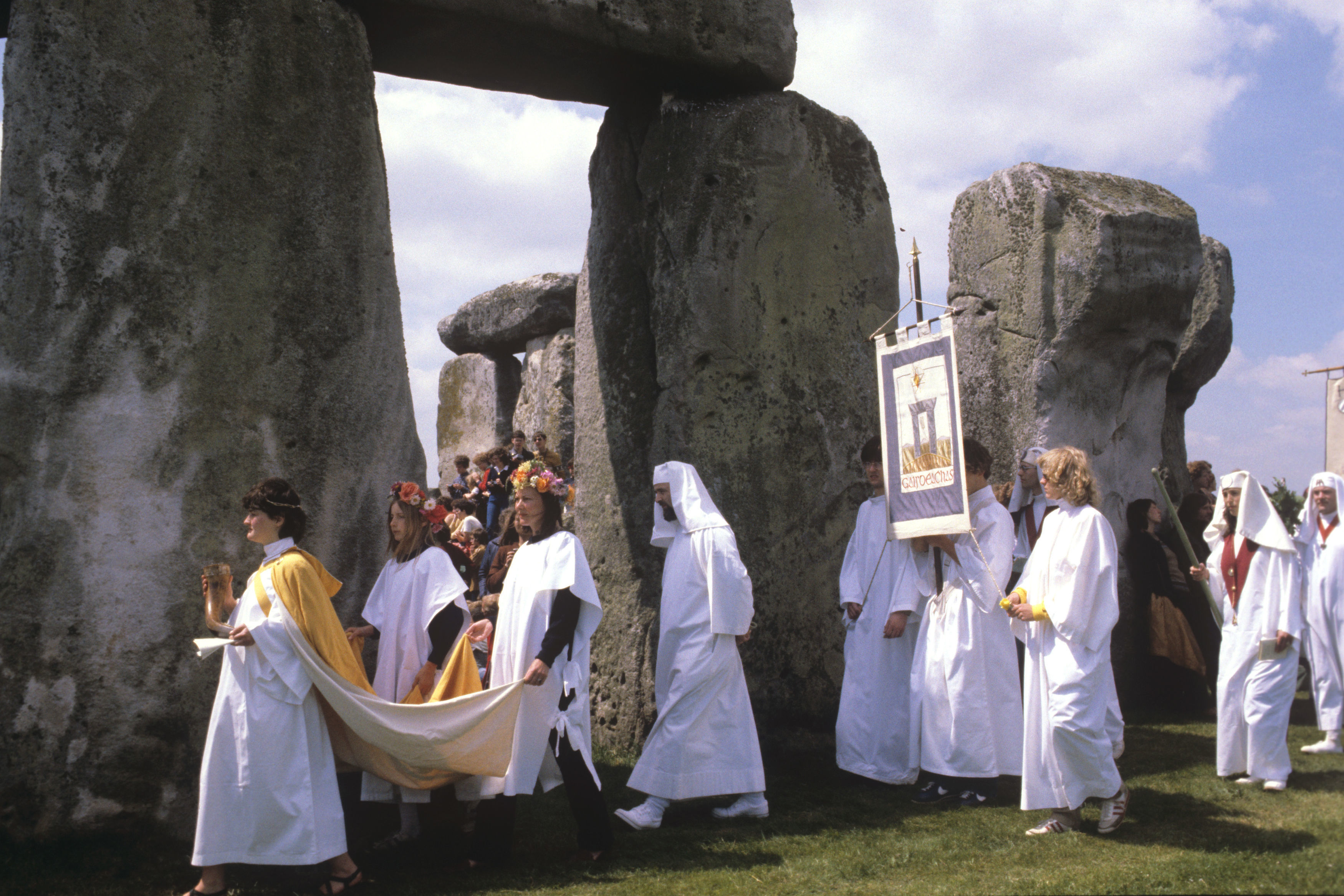 People wearing white robes during a procession in 1981 celebrating the Midsummer Solstice at Stonehenge 
