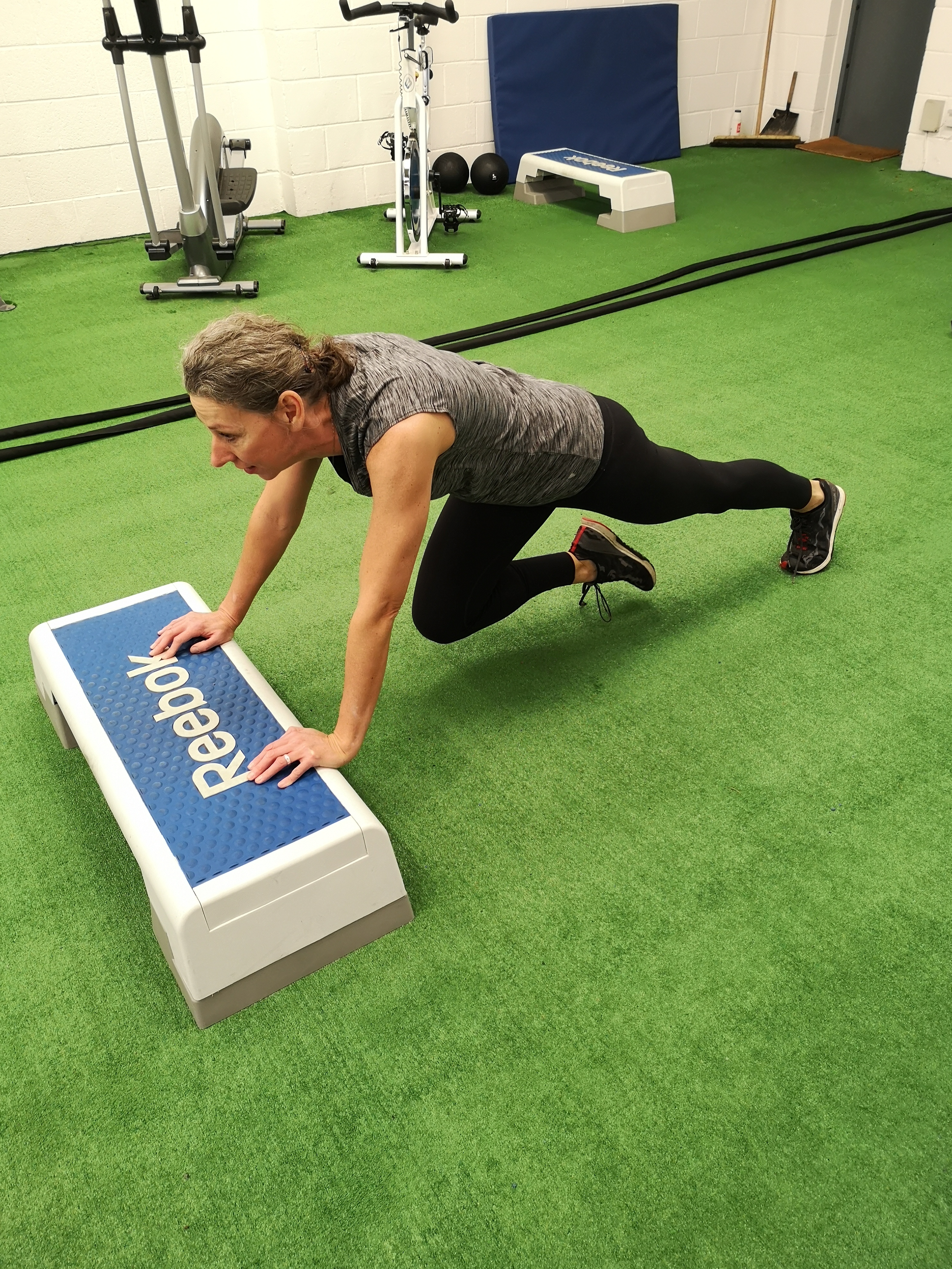 A woman performs mountain climbers (Chris O'Rourke/PA)