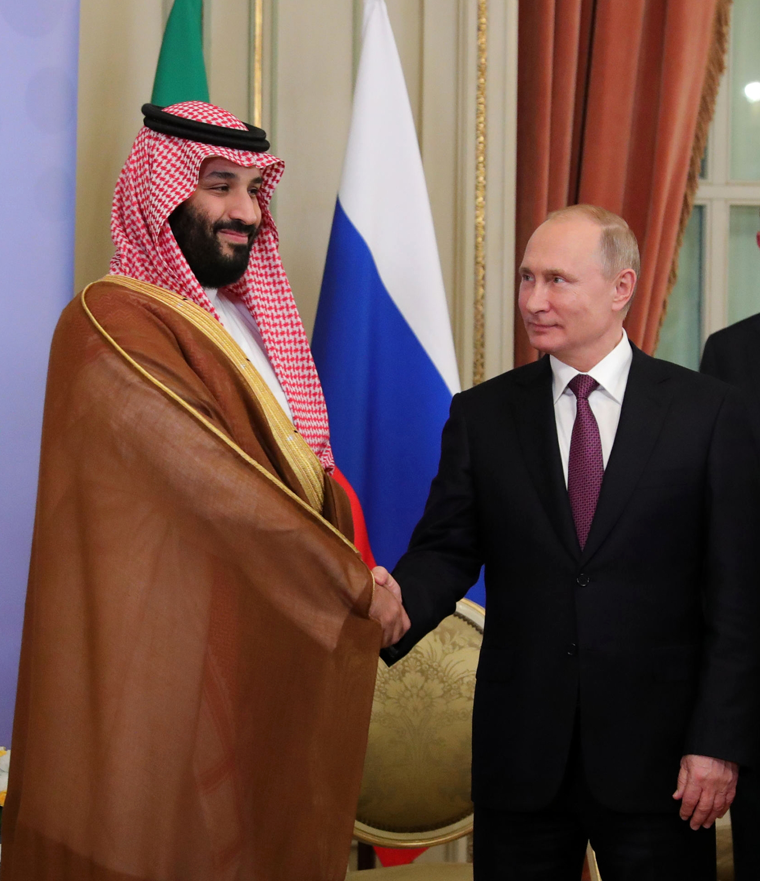 Saudi Arabia's Crown Prince Mohammed bin Salman, left, and Russian President Vladimir Putin, shake hands prior their talks at the G20 summit in Buenos Aires