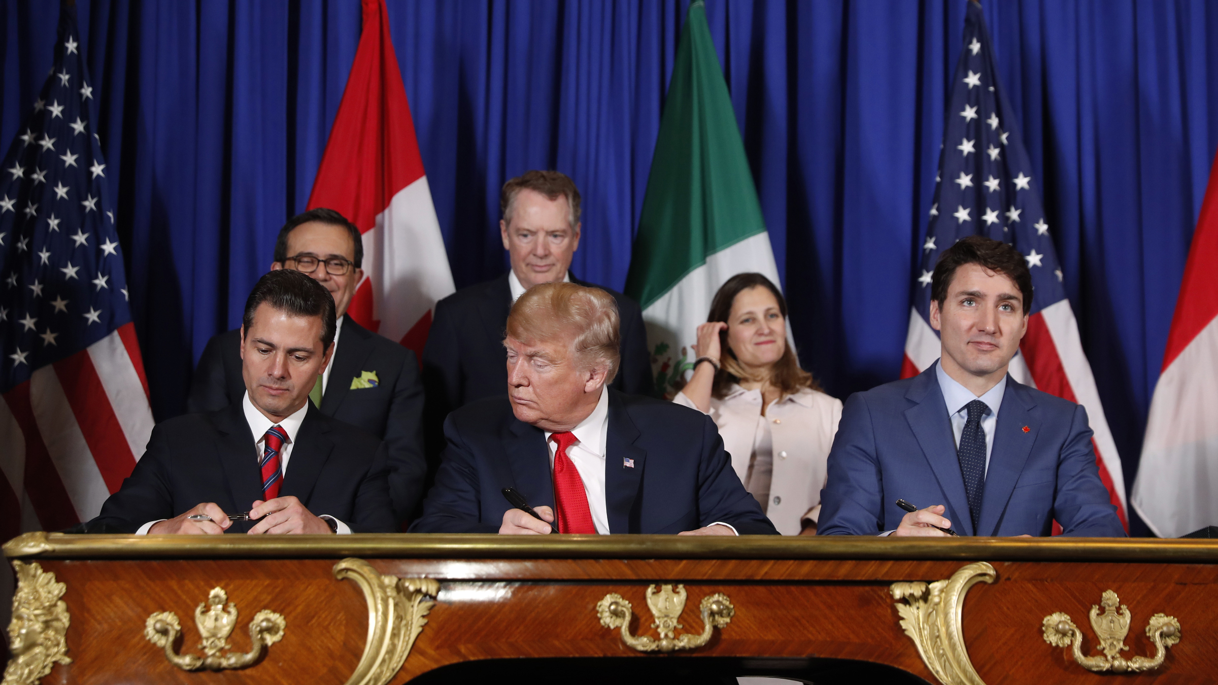 US President Donald Trump, Canada's Prime Minister Justin Trudeau, right, and Mexico's President Enrique Pena Nieto, left, participate in the USMCA signing ceremony in Buenos Aires 