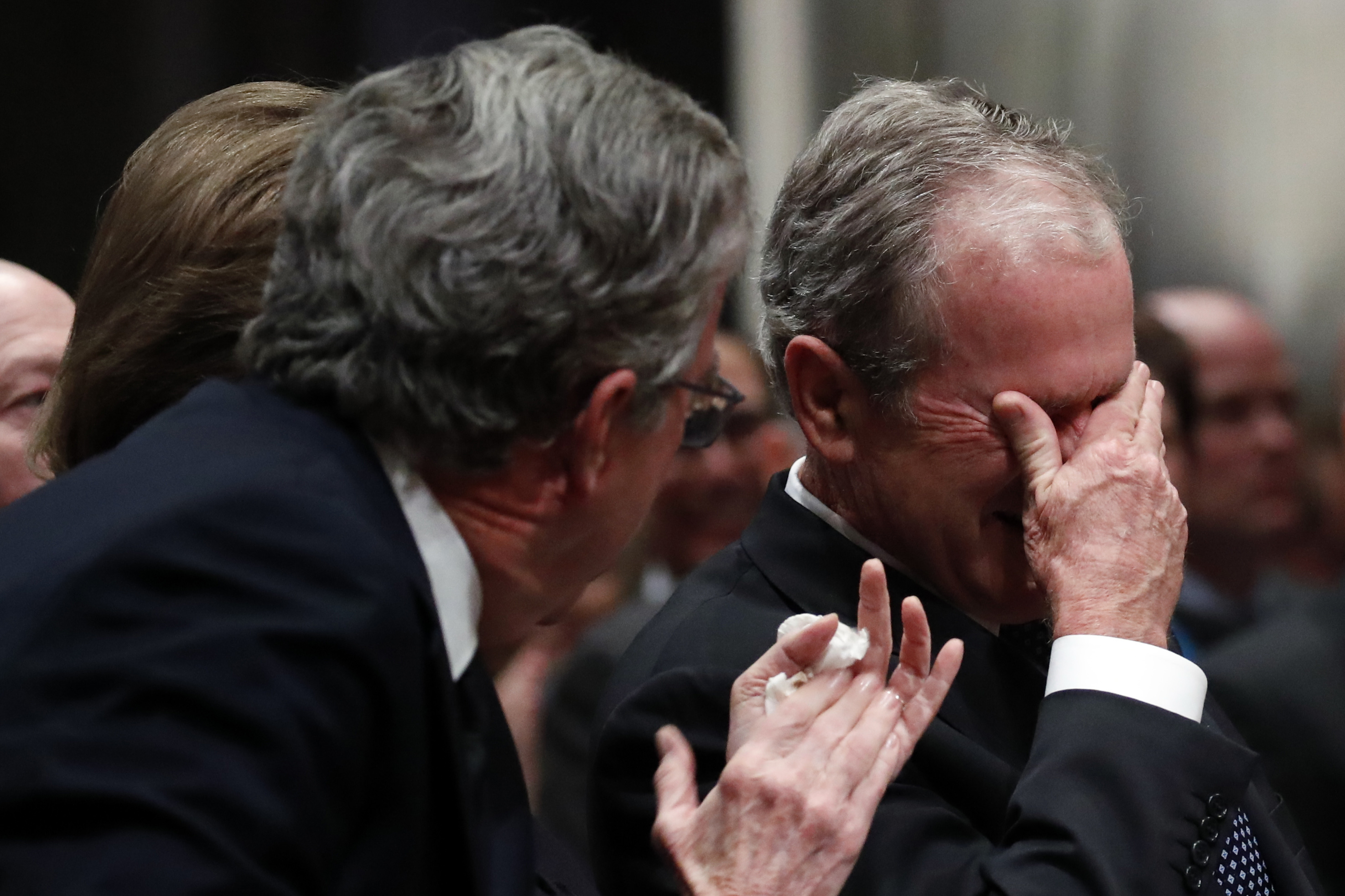 Former president George W Bush cries after speaking during the state funeral for his father