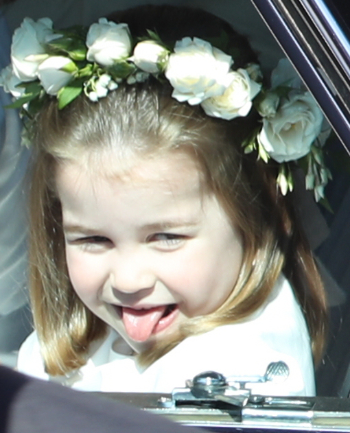 Charlotte sticking out her tongue as she rides in a car to the wedding at St George's Chapel